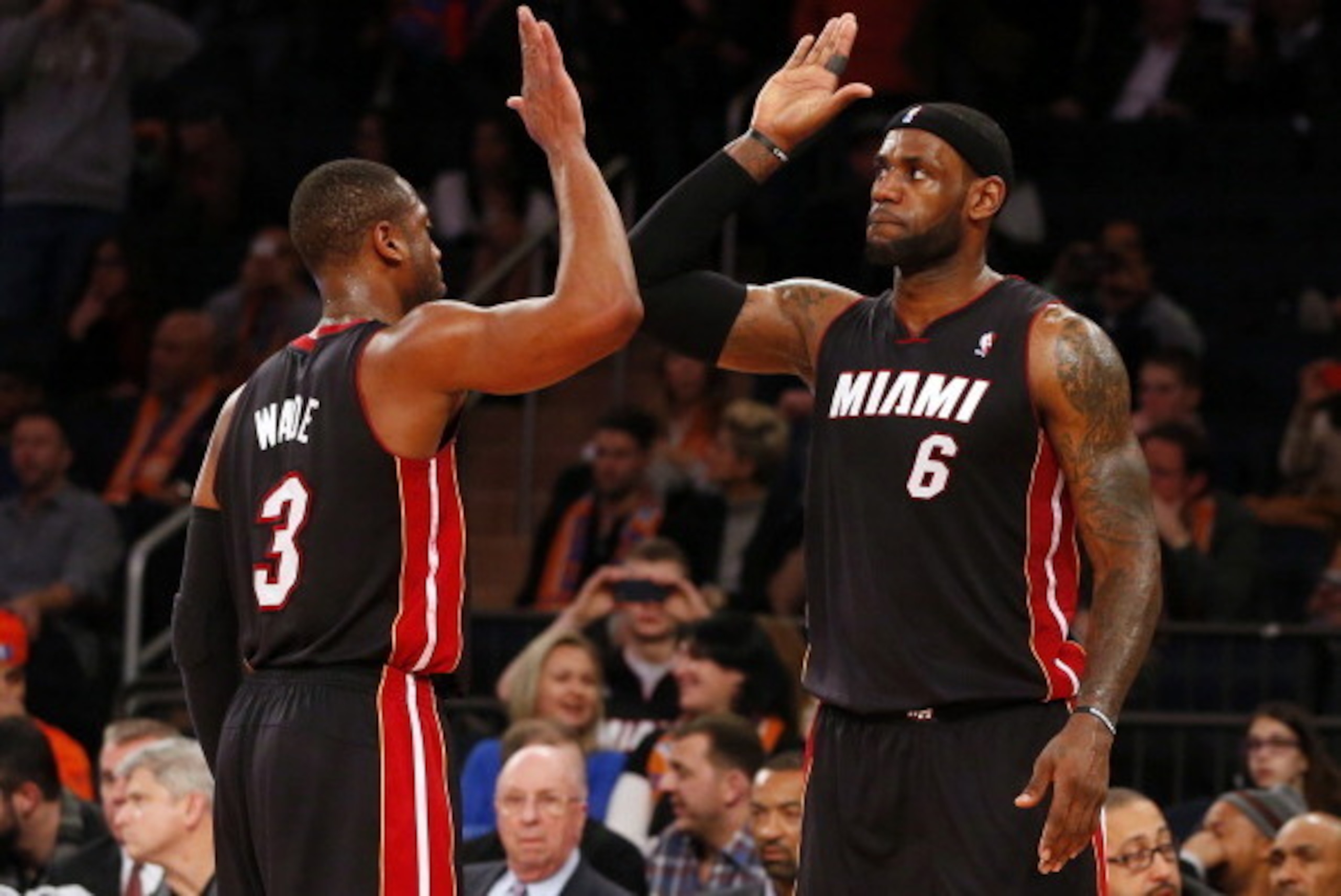 NEW YORK, NY - FEBRUARY 1: Dwyane Wade #3 and LeBron James #6 of the Miami Heat congratulate each other in the closing seconds of a game against the New York Knicks at Madison Square Garden on February. 1, 2014 in New York City. The Heat defeated the Knic