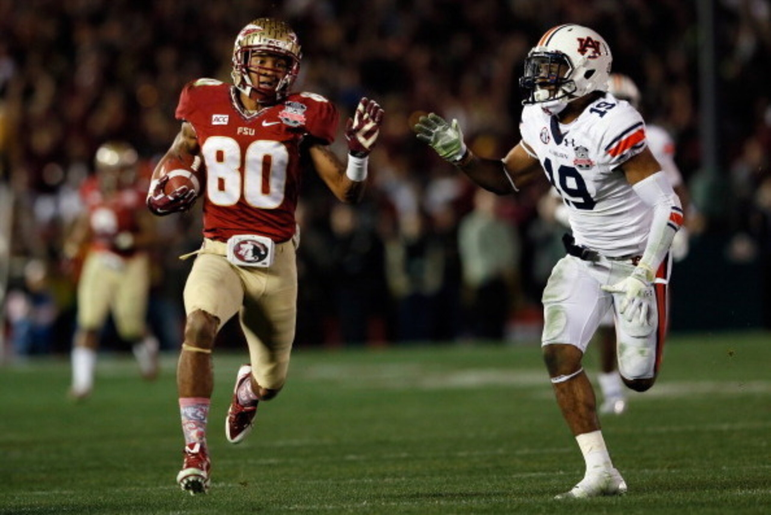 PASADENA, CA - JANUARY 06:  Wide receiver Rashad Greene #80 of the Florida State Seminoles runs after a catch for a 49-yard gain in the fourth quarter against defensive back Ryan White #19 of the Auburn Tigers during the 2014 Vizio BCS National Championsh