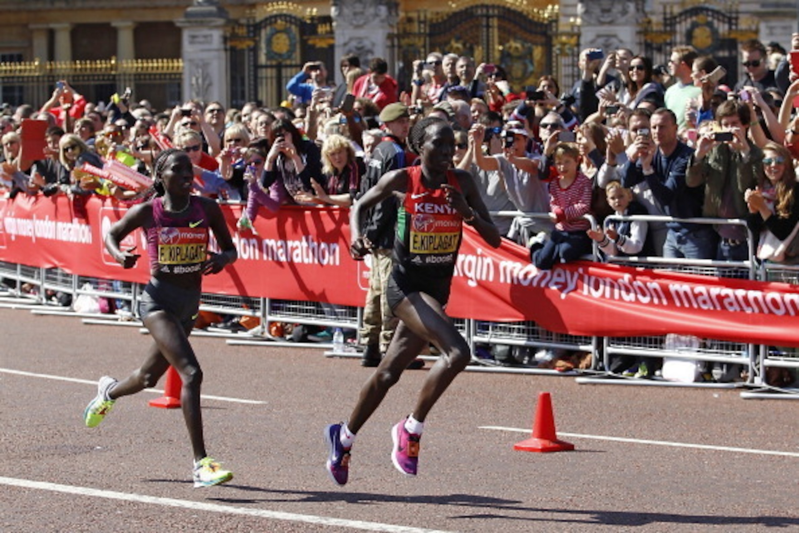 LONDON, ENGLAND - APRIL 13:  Edna Kiplagat of Kenya leads Florence Kiplagat of Kenya as they pass Buckingham Palace during the Virgin London Marathon on April 13, 2014 in London, England.  (Photo by Miles Willis/Getty Images)