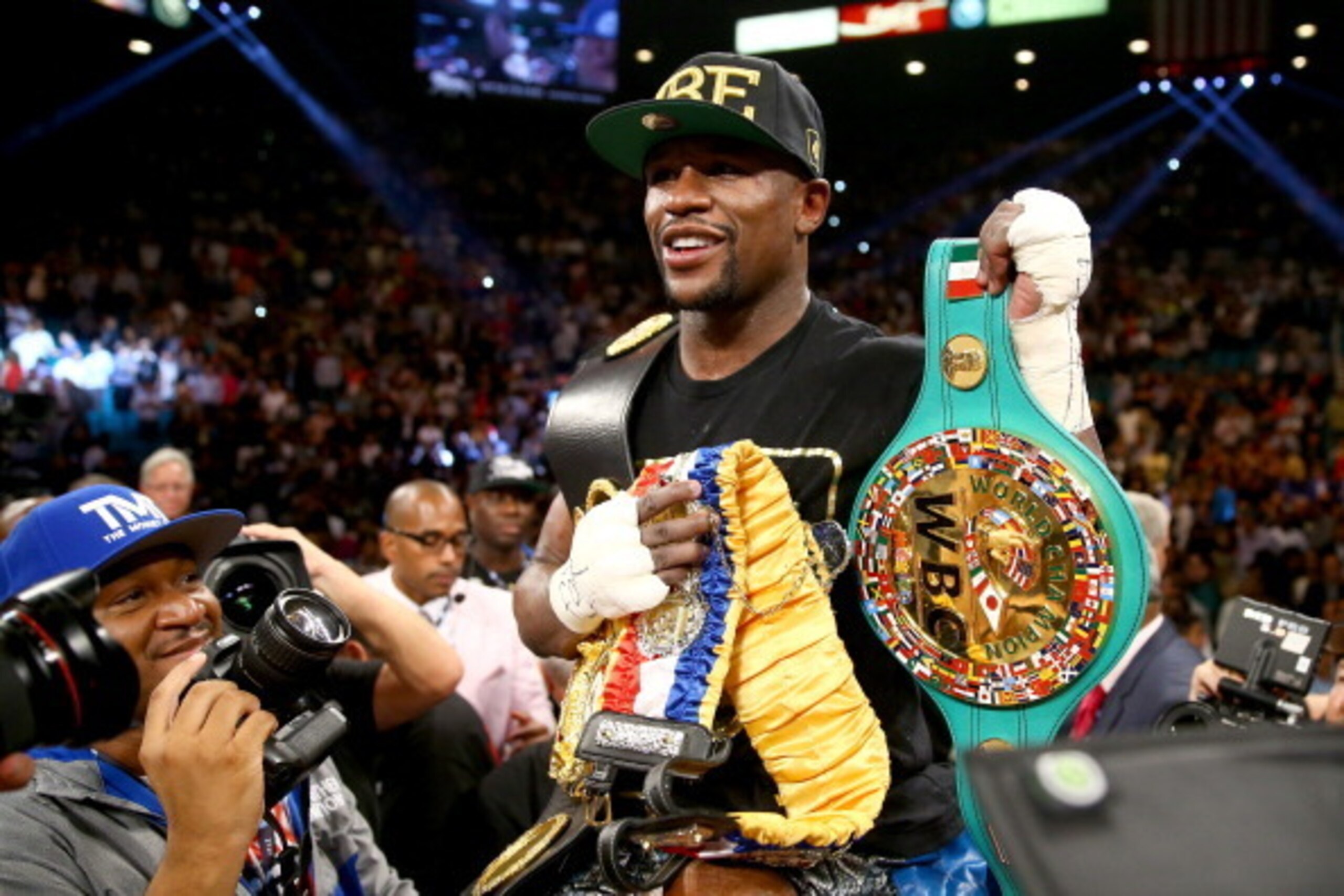 LAS VEGAS, NV - SEPTEMBER 14:  Floyd Mayweather Jr. celebrates his majority decision victory against Canelo Alvarez in their WBC/WBA 154-pound title fight at the MGM Grand Garden Arena on September 14, 2013 in Las Vegas, Nevada.  (Photo by Al Bello/Getty 