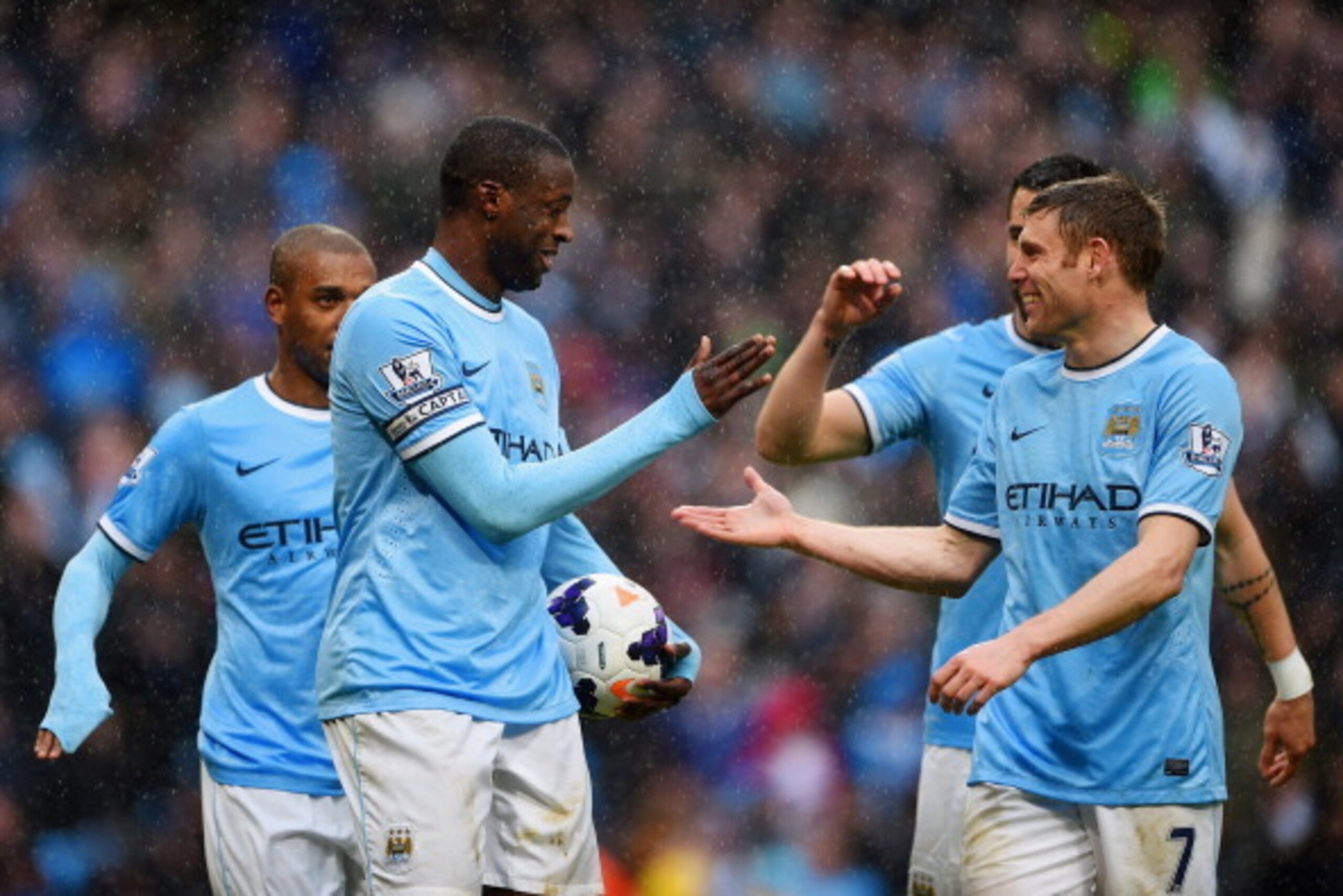 MANCHESTER, ENGLAND - MARCH 22:  Yaya Toure of Manchester City celebrates scoring their second goal with James Milner of Manchester City during the Barclays Premier League match between Manchester City and Fulham at Etihad Stadium on March 22, 2014 in Man