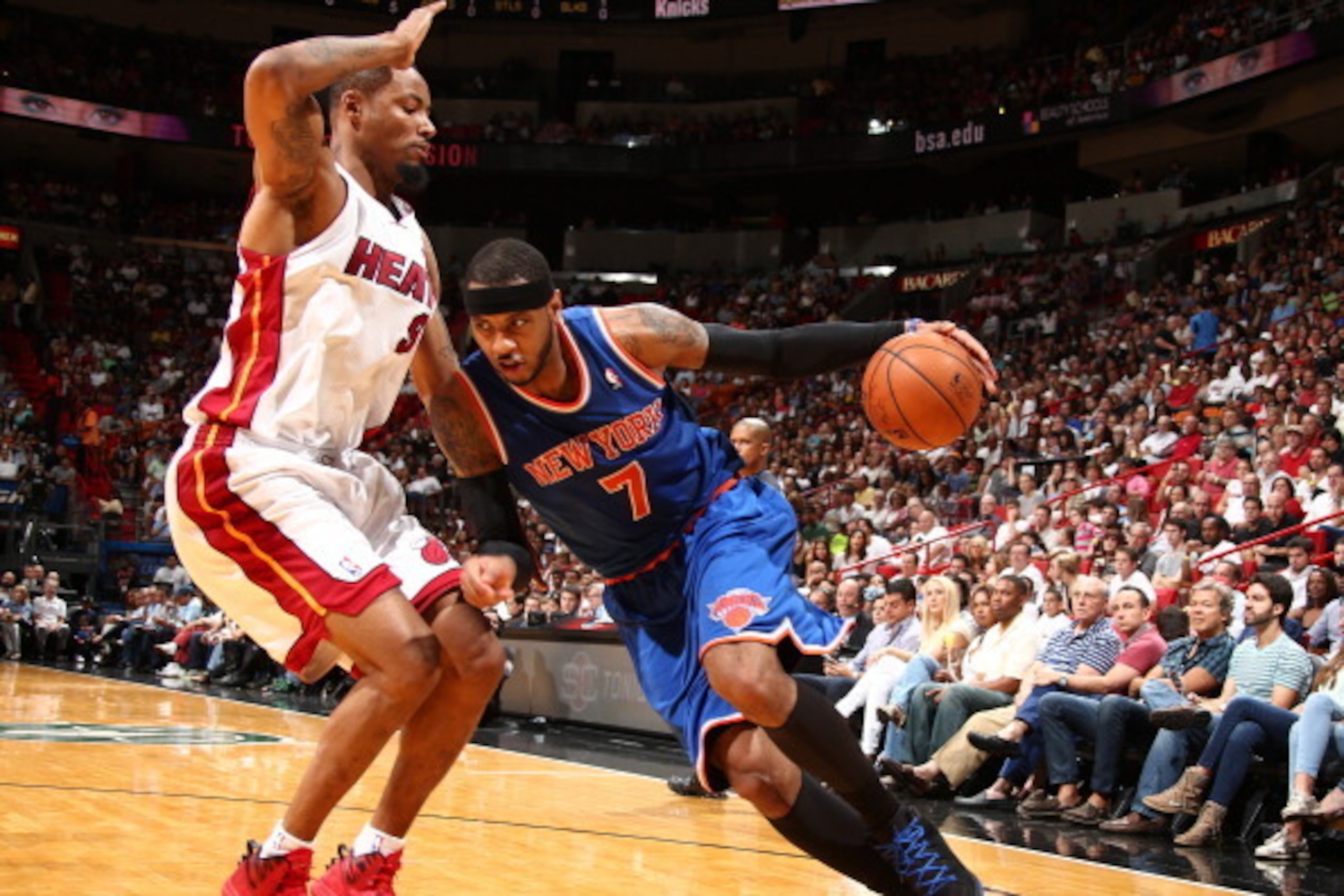 MIAMI, FL - APRIL 6: Carmelo Anthony #7 of the New York Knicks drives against Rashard Lewis #9 of the Miami Heat during a game on April 6, 2014 at American Airlines Arena in Miami, Florida.  NOTE TO USER: User expressly acknowledges and agrees that, by do