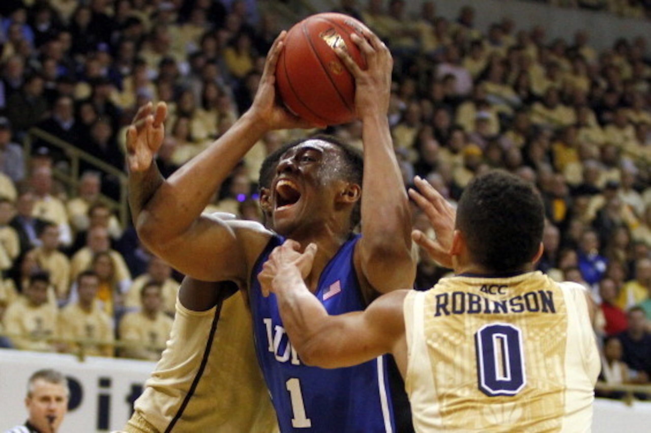 PITTSBURGH, PA - JANUARY 27:  Jabari Parker #1 of the Duke Blue Devils drives to the hoop against James Robinson of the Pittsburgh Panthers at Petersen Events Center on January 27, 2014 in Pittsburgh, Pennsylvania.  (Photo by Justin K. Aller/Getty Images)