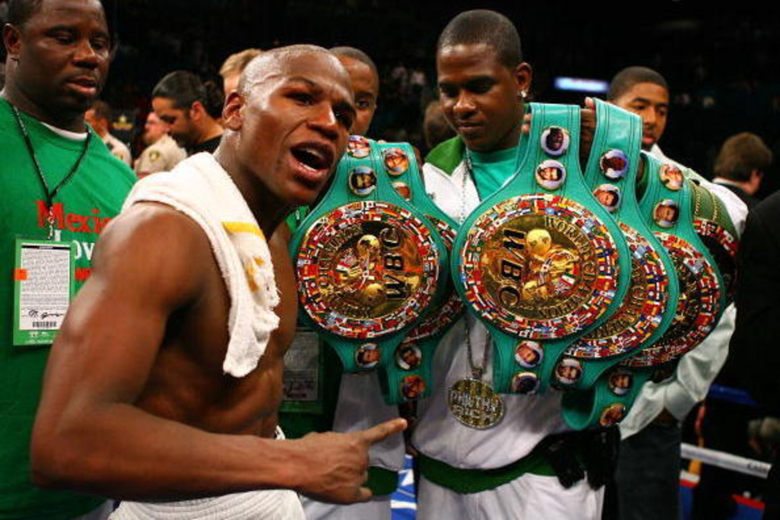 LAS VEGAS - MAY 05:  Floyd Mayweather Jr. (L)  celebrates his split decision victory against Oscar De La Hoya with a member of his camp after their WBC super welterweight championship fight at the MGM Grand Garden Arena May 5, 2007 in Las Vegas, Nevada.
