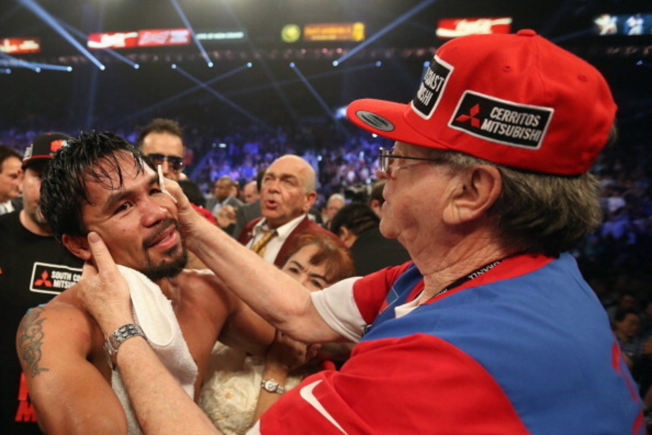 LAS VEGAS, NV - APRIL 12:  Manny Pacquiao receives treatment from his corner following his match against Timothy Bradley at the MGM Grand Garden Arena on April 12, 2014 in Las Vegas, Nevada.  (Photo by Jeff Gross/Getty Images)