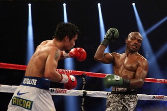 LAS VEGAS, NV - APRIL 12:  Manny Pacquiao throws a left hand at Timothy Bradley at the MGM Grand Garden Arena on April 12, 2014 in Las Vegas, Nevada.  (Photo by Jeff Gross/Getty Images)