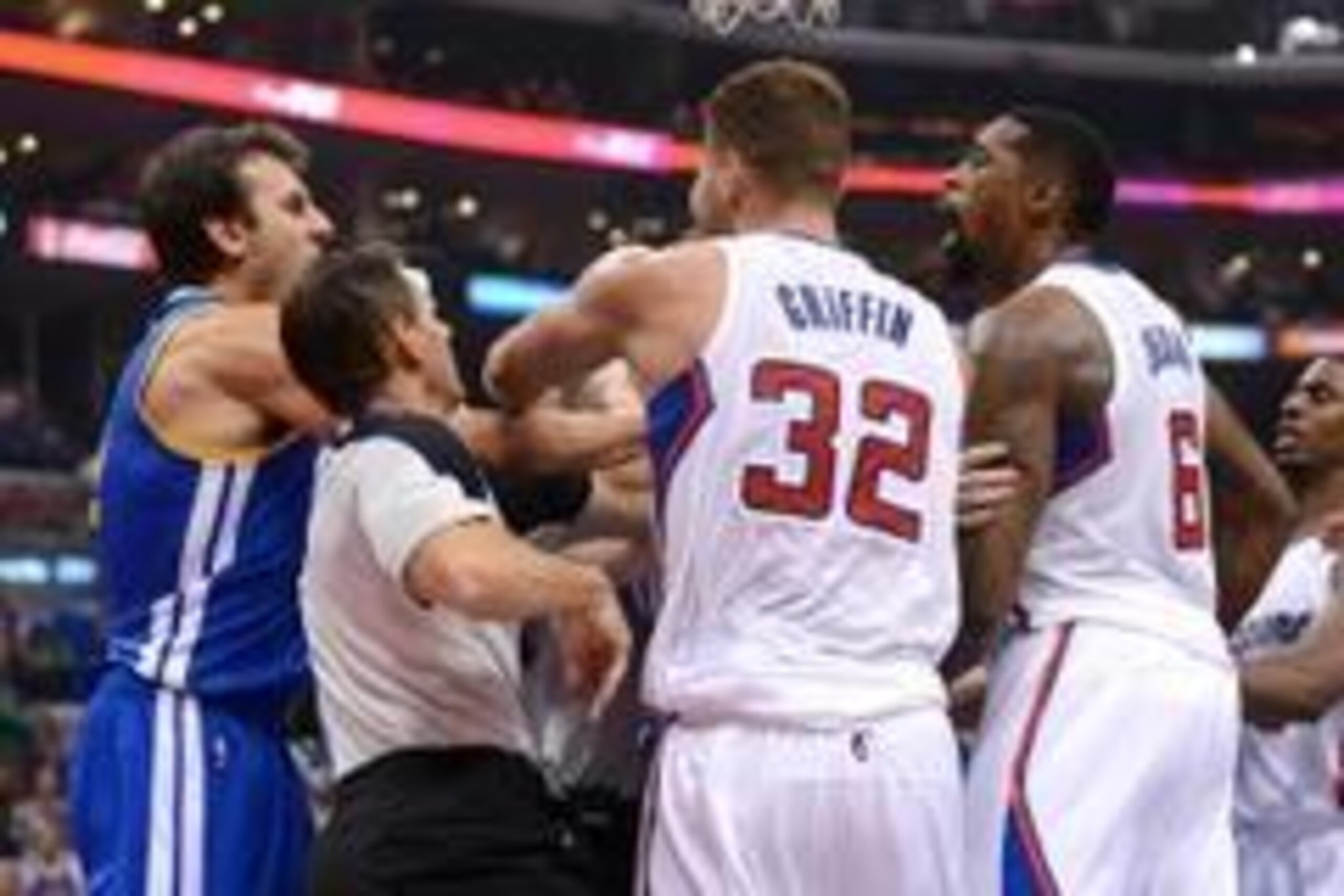 Oct 31, 2013; Los Angeles, CA, USA;   NBA referee Mark Ayotte (56) and Los Angeles Clippers power forward Blake Griffin (32) separate center DeAndre Jordan (6) after he was fouled by Golden State Warriors center Andrew Bogut (far left) in the second quart