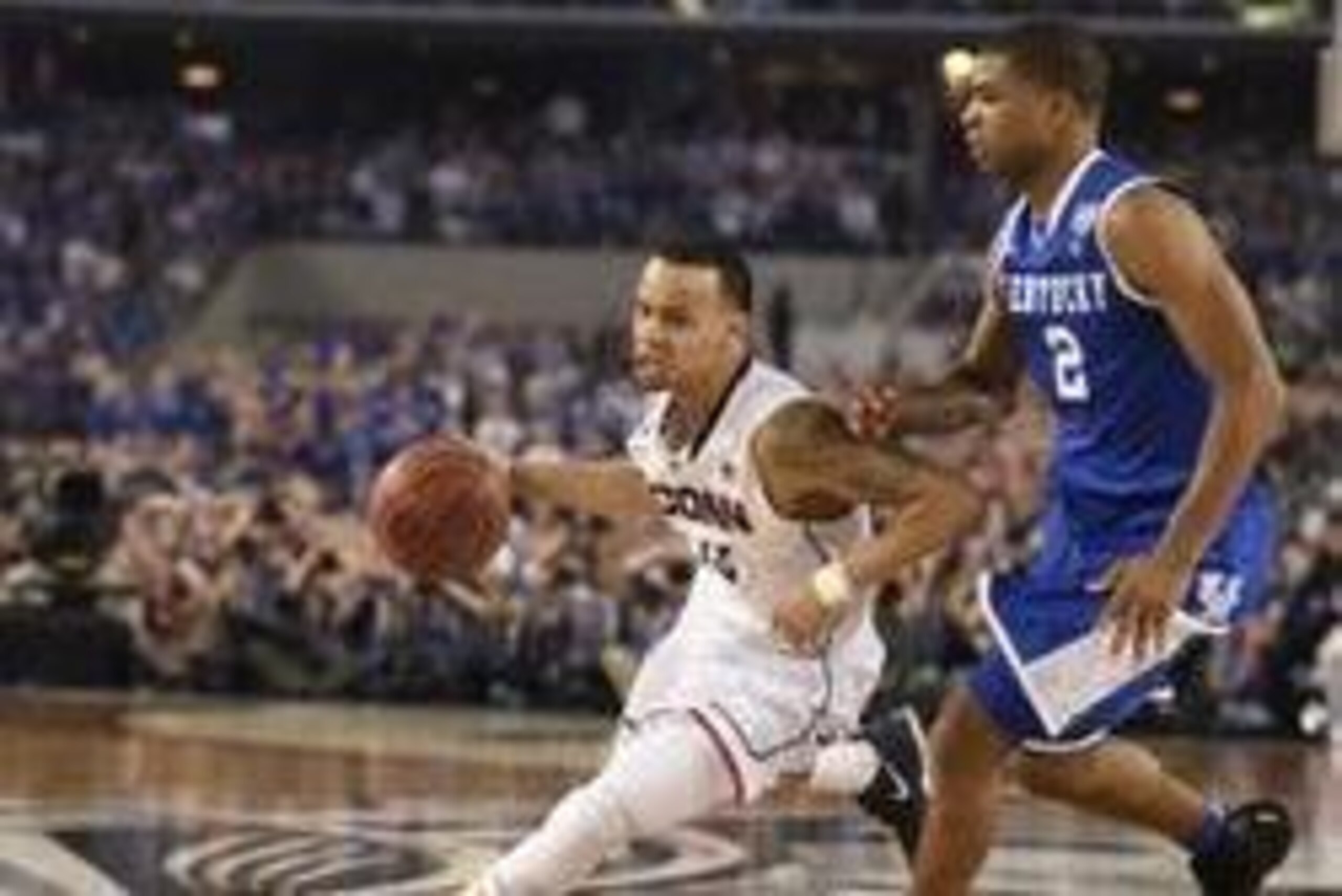Apr 7, 2014; Arlington, TX, USA; Connecticut Huskies guard Shabazz Napier (13) drives to the basket defended by Kentucky Wildcats guard Aaron Harrison (2) in the second half during the championship game of the Final Four in the 2014 NCAA Mens Division I C