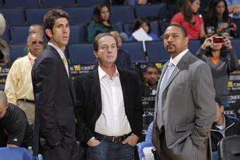 OAKLAND, CA - OCTOBER 11: Bob Myers, Joe Lacob, and Mark Jackson chat on the sideline during a game against the Maccabi Haifa on October 11, 2012 at Oracle Arena in Oakland, California. NOTE TO USER: User expressly acknowledges and agrees that, by downloa