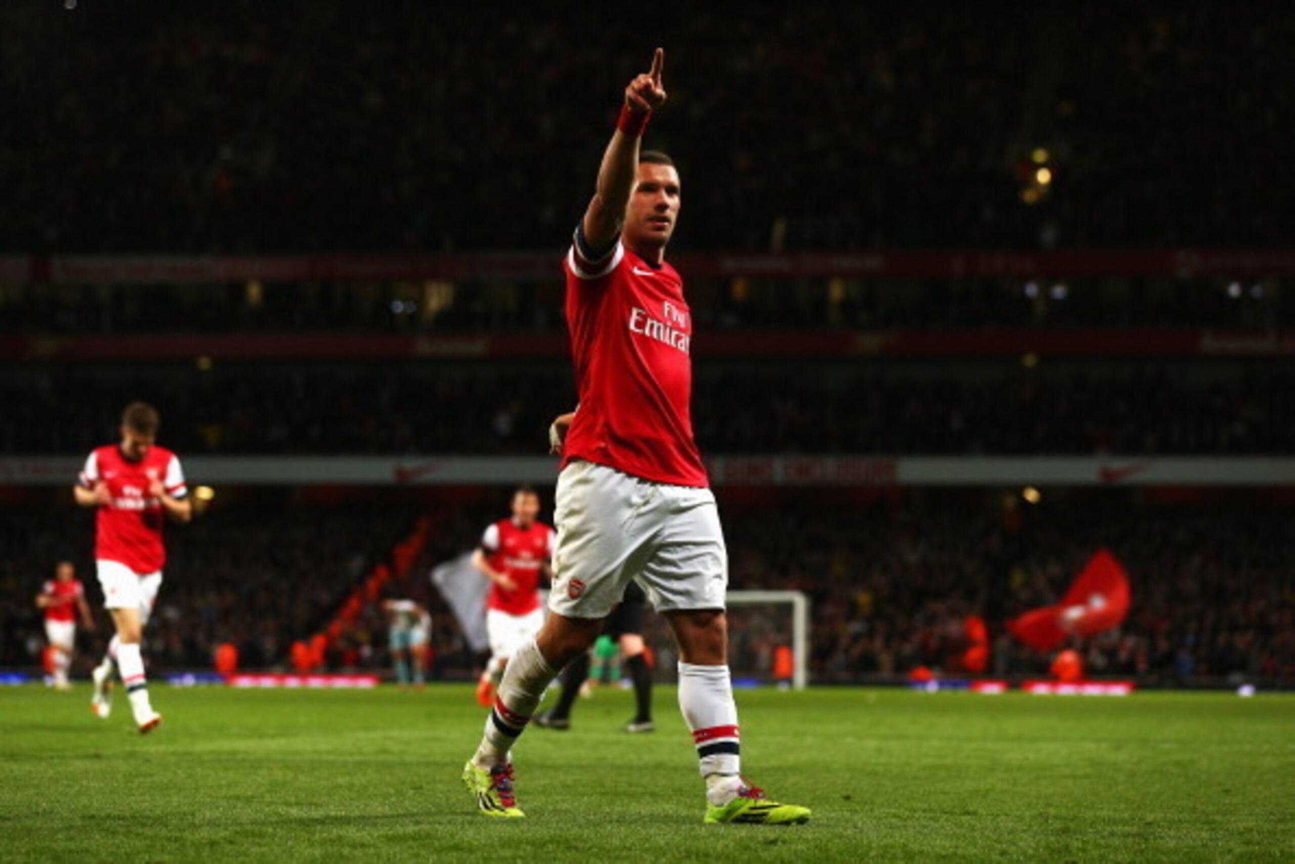 LONDON, ENGLAND - APRIL 15:  Lukas Podolski of Arsenal celebrates as he scores their third goal during the Barclays Premier League match between Arsenal and West Ham United at Emirates Stadium on April 15, 2014 in London, England.  (Photo by Paul Gilham/G