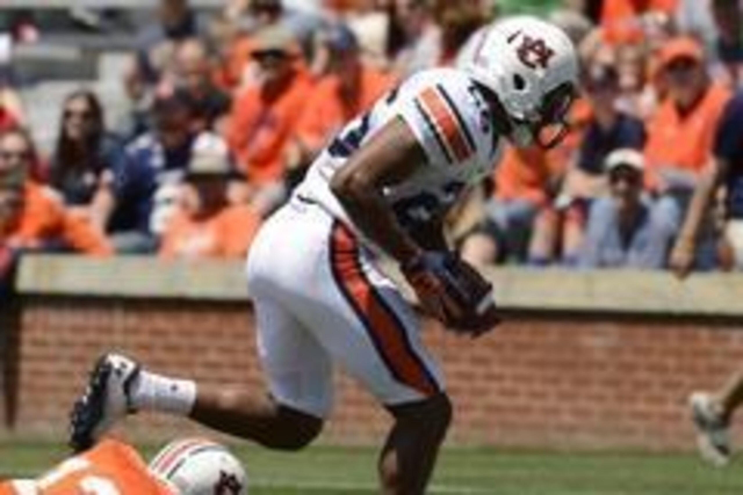 Apr 20, 2013; Auburn, AL, USA; Auburn linebacker Justin Garrett (26) scores a defensive touchdown on a high snap lose ball past Auburn quarterback Jonathan Wallace (12) during their A-Day spring game at Jordan-Hare Stadium. Mandatory Credit: John David Me