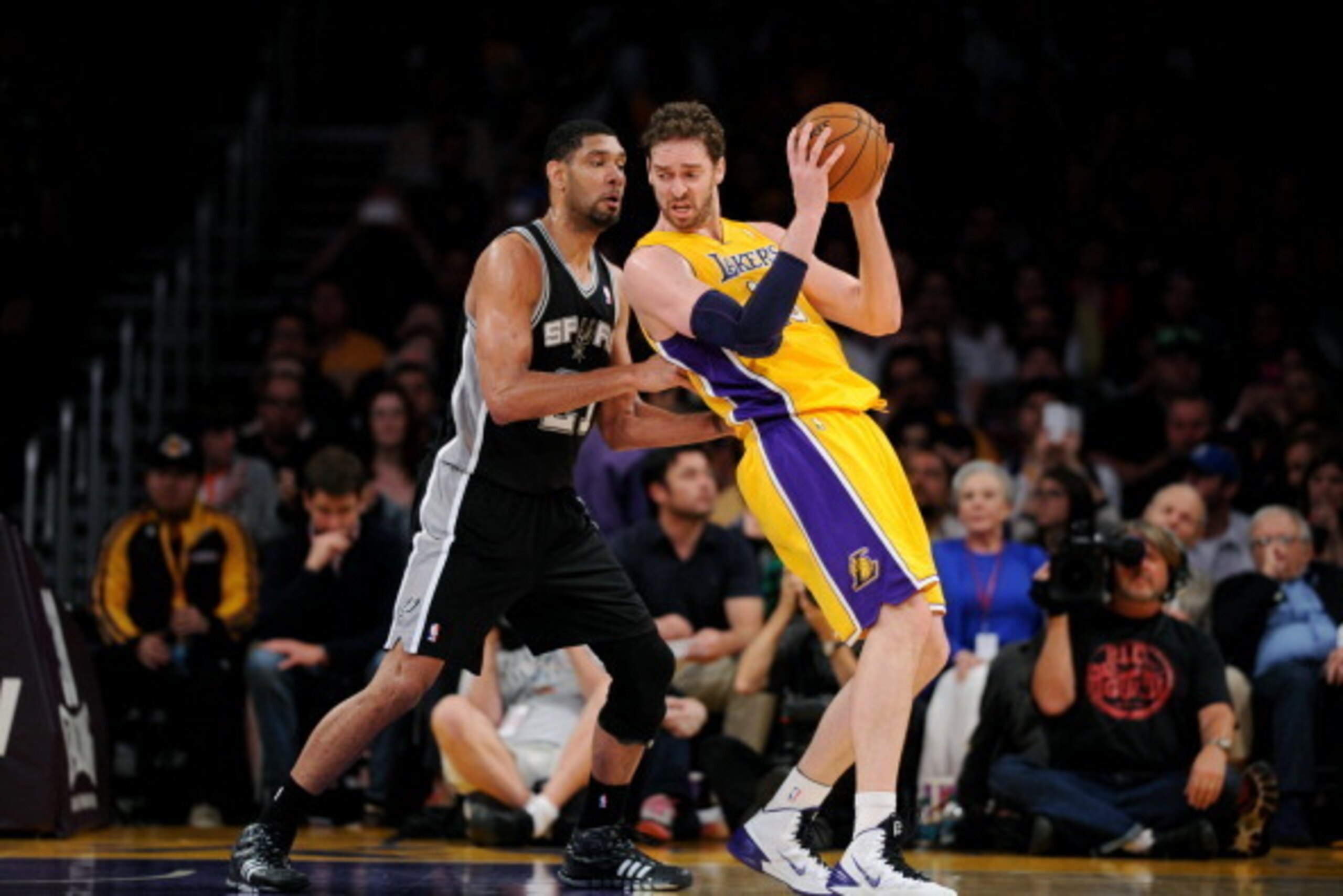 LOS ANGELES, CA - MARCH 19: Pau Gasol #16 of the Los Angeles Lakers handles the ball against Tim Duncan #21 of the San Antonio Spurs at Staples Center on March 19, 2014 in Los Angeles, California. NOTE TO USER: User expressly acknowledges and agrees that,
