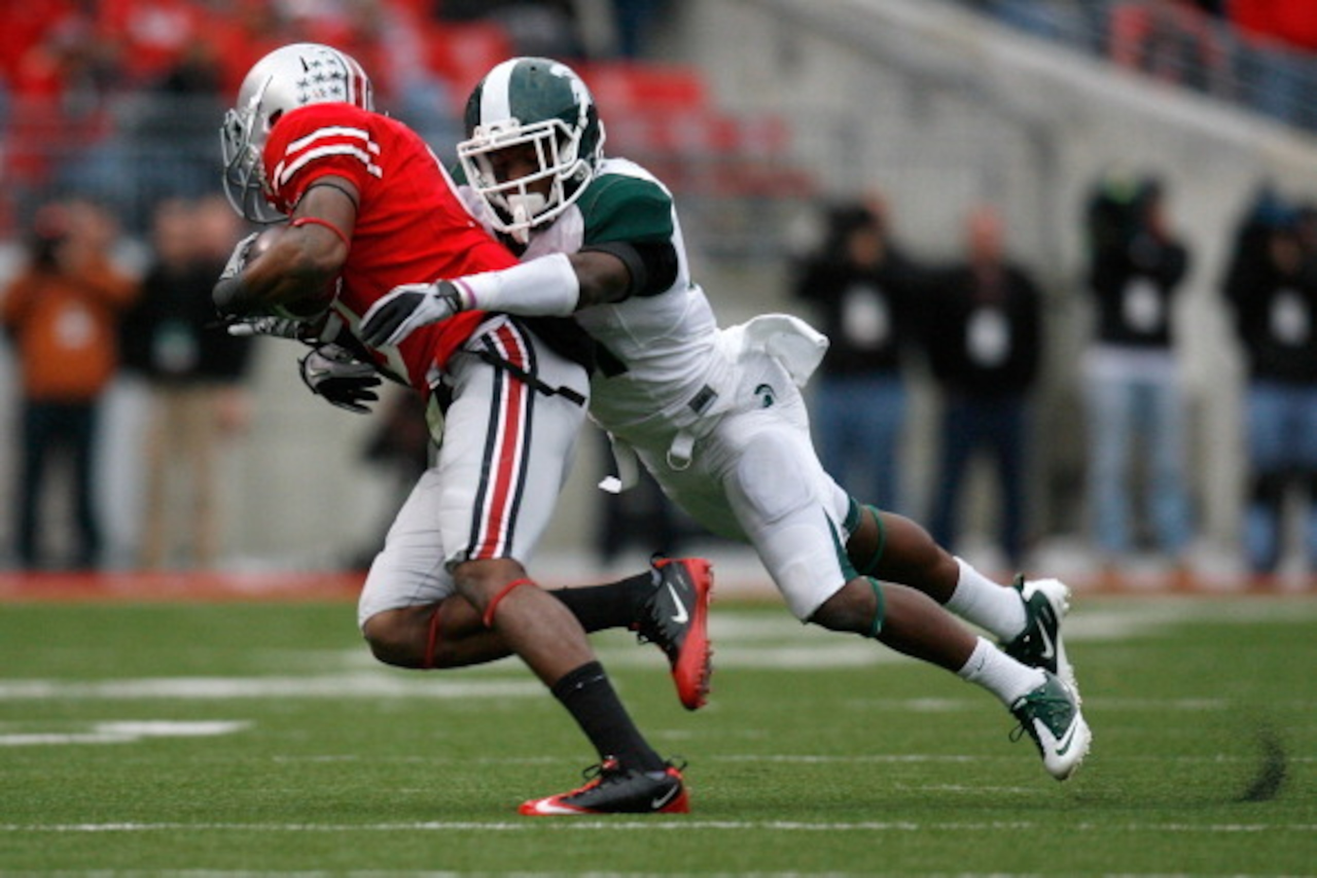 COLUMBUS, OH - OCTOBER 1:  Darqueze Dennard #31 of the Michigan State Spartans tackles Verlon Reed #9 of the Ohio State Buckeyes during the second half on October 1, 2011 at Ohio Stadium in Columbus, Ohio. Michigan State defeated Ohio State 10-7. (Photo b