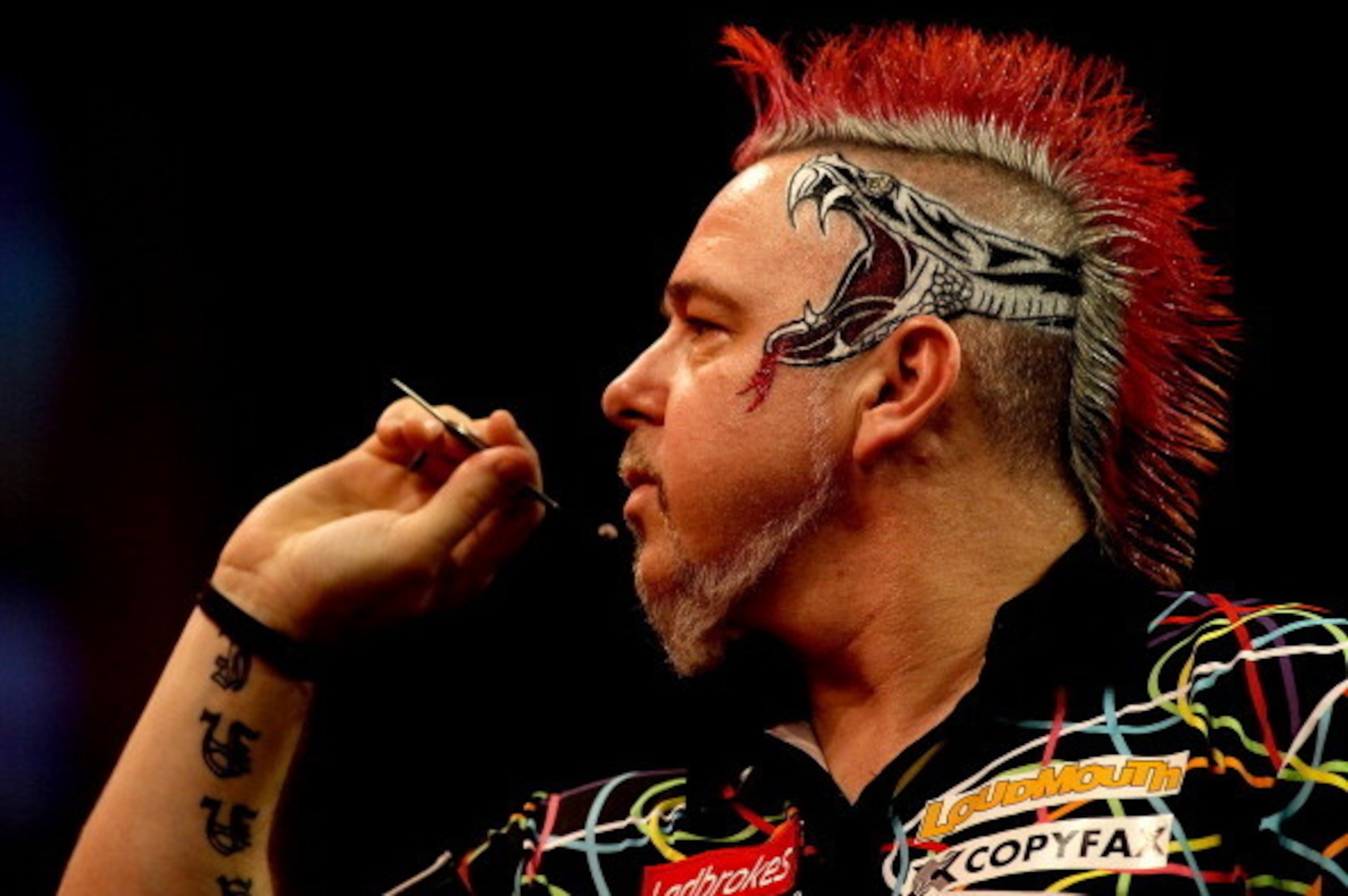 LONDON, ENGLAND - JANUARY 01: Peter Wright of Scotland prepares to throw during the final of the Ladbrokes.com World Darts Championships against Michael van Gerwen of The Netherlands at Alexandra Palace on January 1, 2014 in London, England.  (Photo by Be