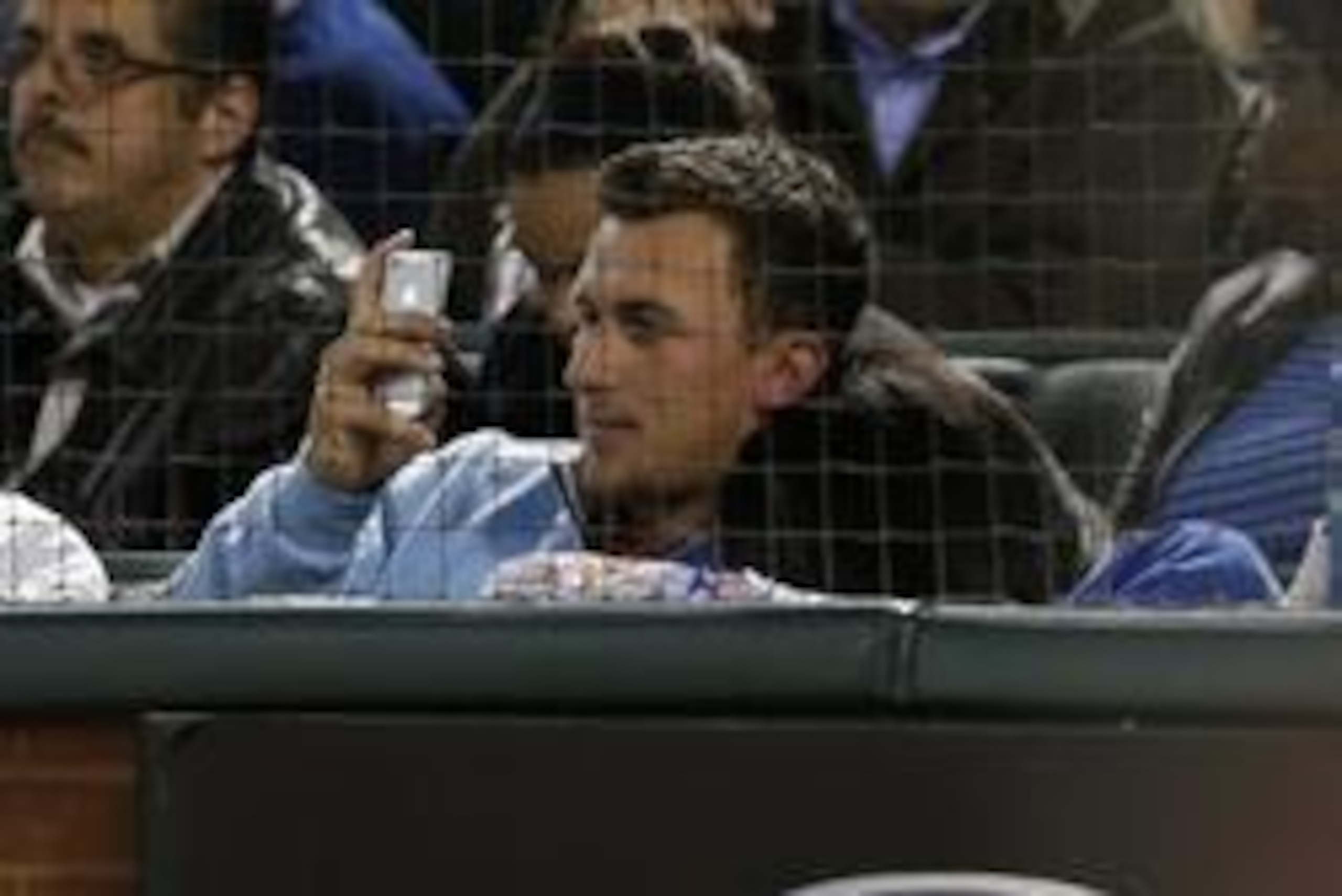 Apr 15, 2014; Arlington, TX, USA; Johnny Manziel sits front row to watch the Texas Rangers play against the Seattle Mariners at Globe Life Park in Arlington. The Rangers beat the Mariners 5-0. Mandatory Credit: Matthew Emmons-USA TODAY Sports