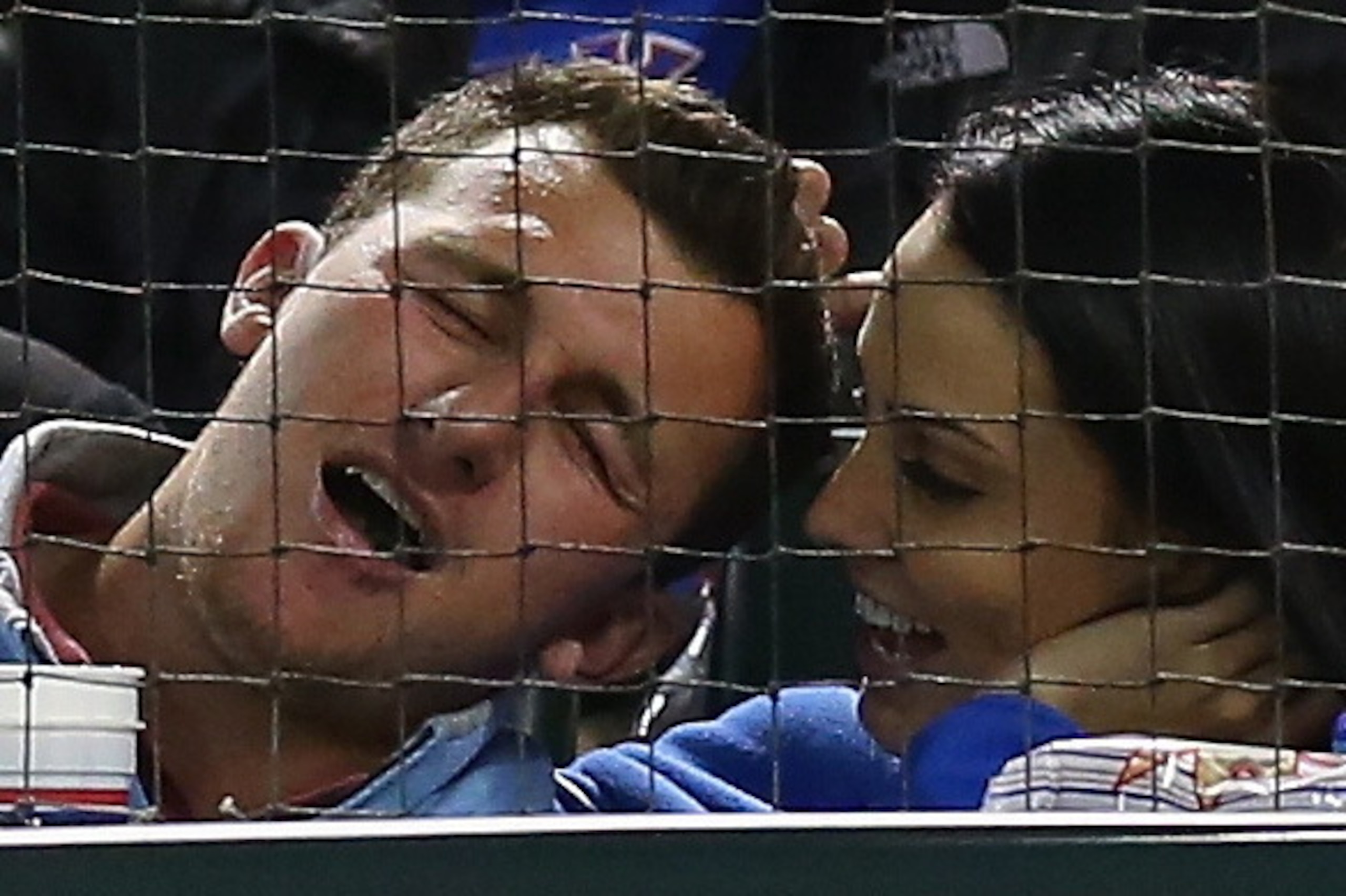 ARLINGTON, TX - APRIL 15:  Football player, Johnny Manziel hugs a friend during play between the Seattle Mariners and the Texas Rangers at Globe Life Park in Arlington on April 15, 2014 in Arlington, Texas.  (Photo by Ronald Martinez/Getty Images)