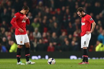 MANCHESTER, ENGLAND - MARCH 25:   Javier Hernandez of Manchester United and team-mate Juan Mata (R) look dejected after conceding the third goal during the Barclays Premier League match between Manchester United and Manchester City at Old Trafford on Marc