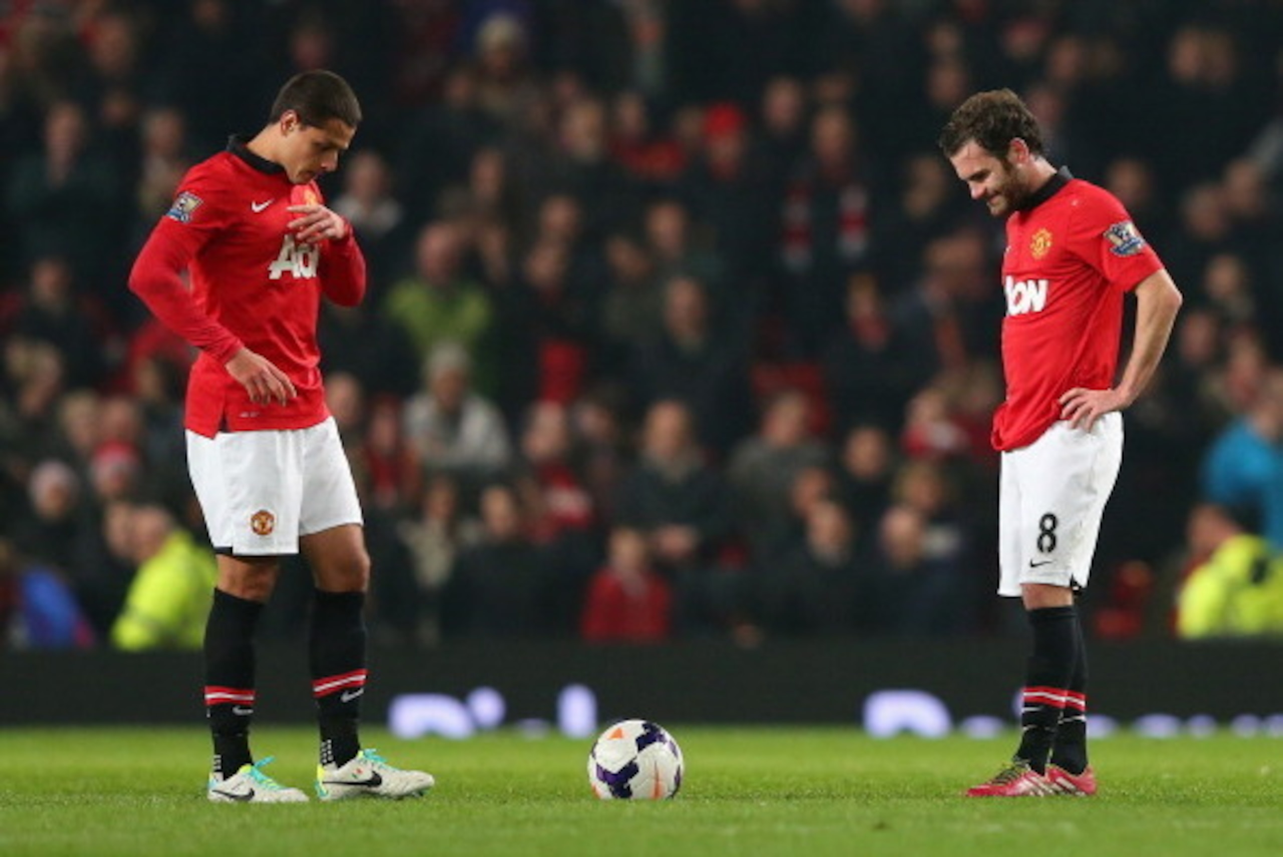 MANCHESTER, ENGLAND - MARCH 25:   Javier Hernandez of Manchester United and team-mate Juan Mata (R) look dejected after conceding the third goal during the Barclays Premier League match between Manchester United and Manchester City at Old Trafford on Marc