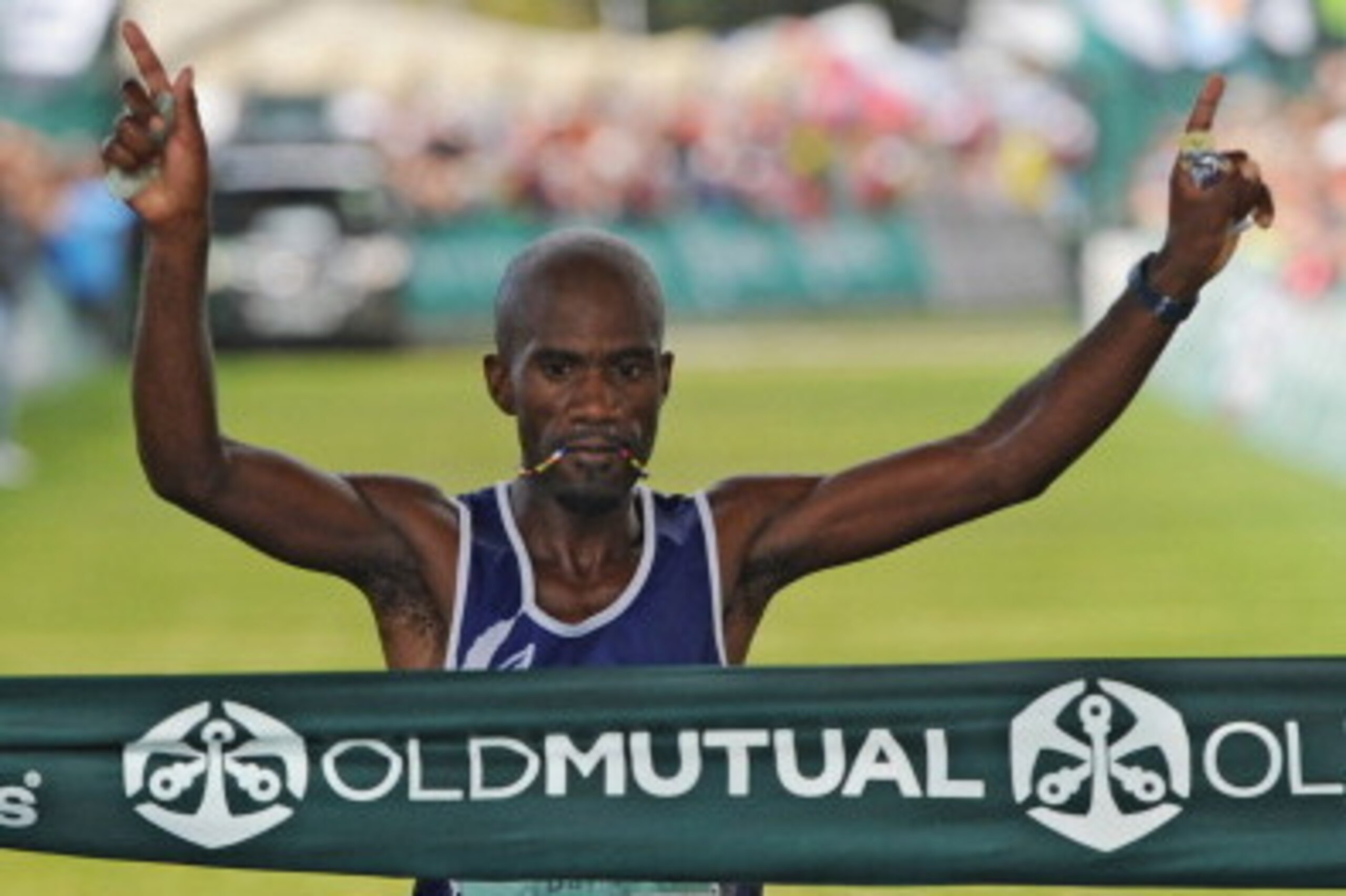 CAPE TOWN, SOUTH AFRICA - MARCH 30:  Winner David Gatebe celebrates on the finishing line during the Old Mutual Two Oceans Marathon on March 30, 2013 in Cape Town, South Africa.  (Photo by Gallo Images/Getty Images)