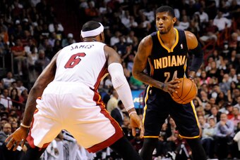 Apr 11, 2014; Miami, FL, USA; Indiana Pacers forward Paul George (24) is pressured by Miami Heat forward LeBron James (6) during the second half at American Airlines Arena. Miami won 98-86. Mandatory Credit: Steve Mitchell-USA TODAY Sports