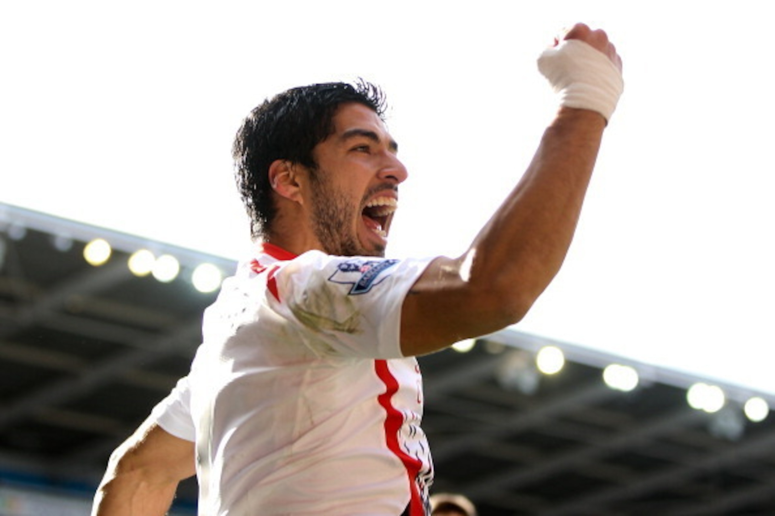 CARDIFF, WALES - MARCH 22:  Luis Suarez of Liverpool celebrates after scoring his team's fourth goal of the game during the Barclays Premier League match between Cardiff City and Liverpool at Cardiff City Stadium on March 22, 2014 in Cardiff, Wales.  (Pho