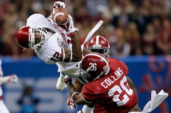 NEW ORLEANS, LA - JANUARY 02:  Derrick Woods #12 of the Oklahoma Sooners makes a catch over Landon Collins #26 of the Alabama Crimson Tide during the Allstate Sugar Bowl at the Mercedes-Benz Superdome on January 2, 2014 in New Orleans, Louisiana.  (Photo 