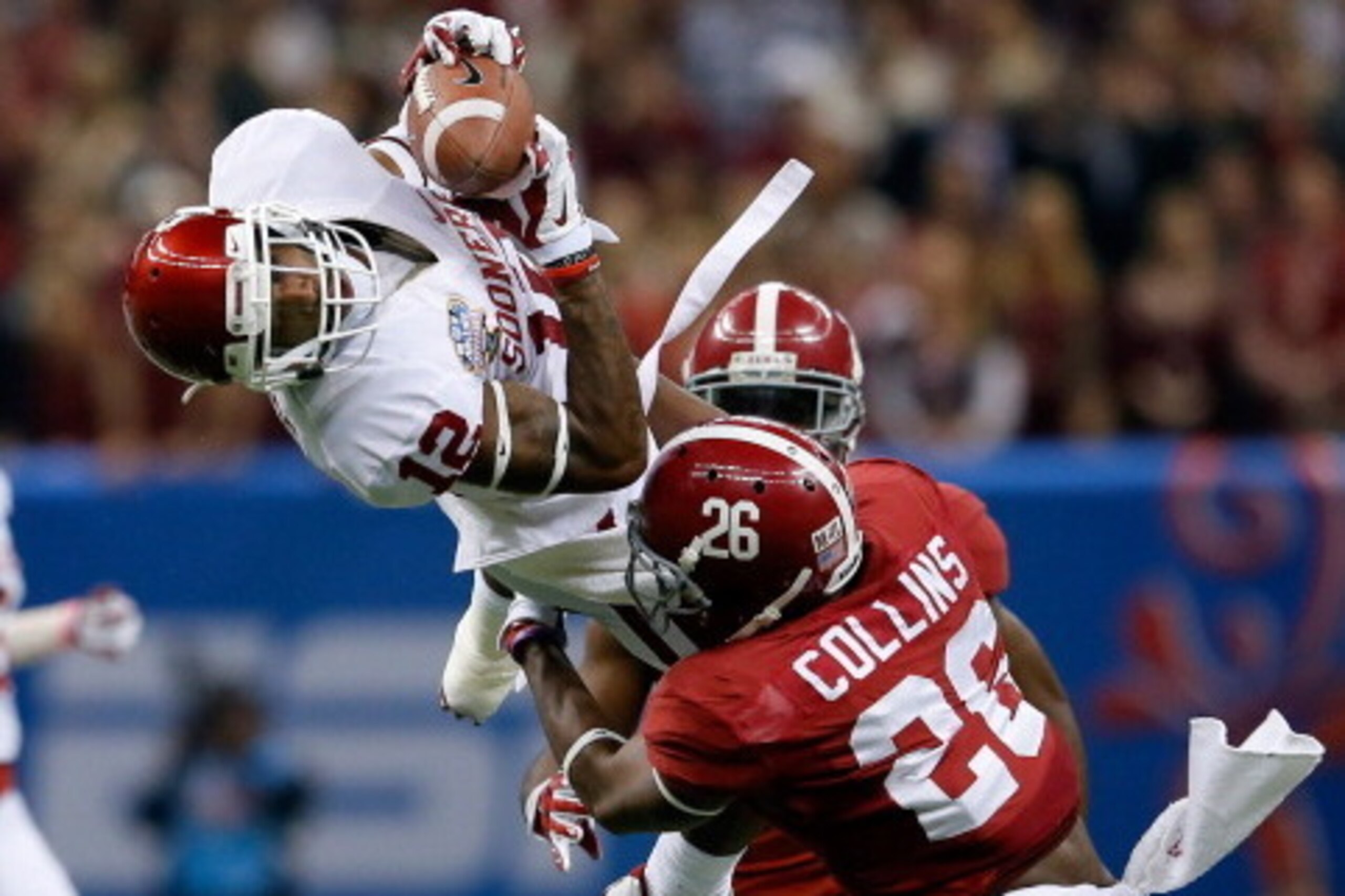 NEW ORLEANS, LA - JANUARY 02:  Derrick Woods #12 of the Oklahoma Sooners makes a catch over Landon Collins #26 of the Alabama Crimson Tide during the Allstate Sugar Bowl at the Mercedes-Benz Superdome on January 2, 2014 in New Orleans, Louisiana.  (Photo 