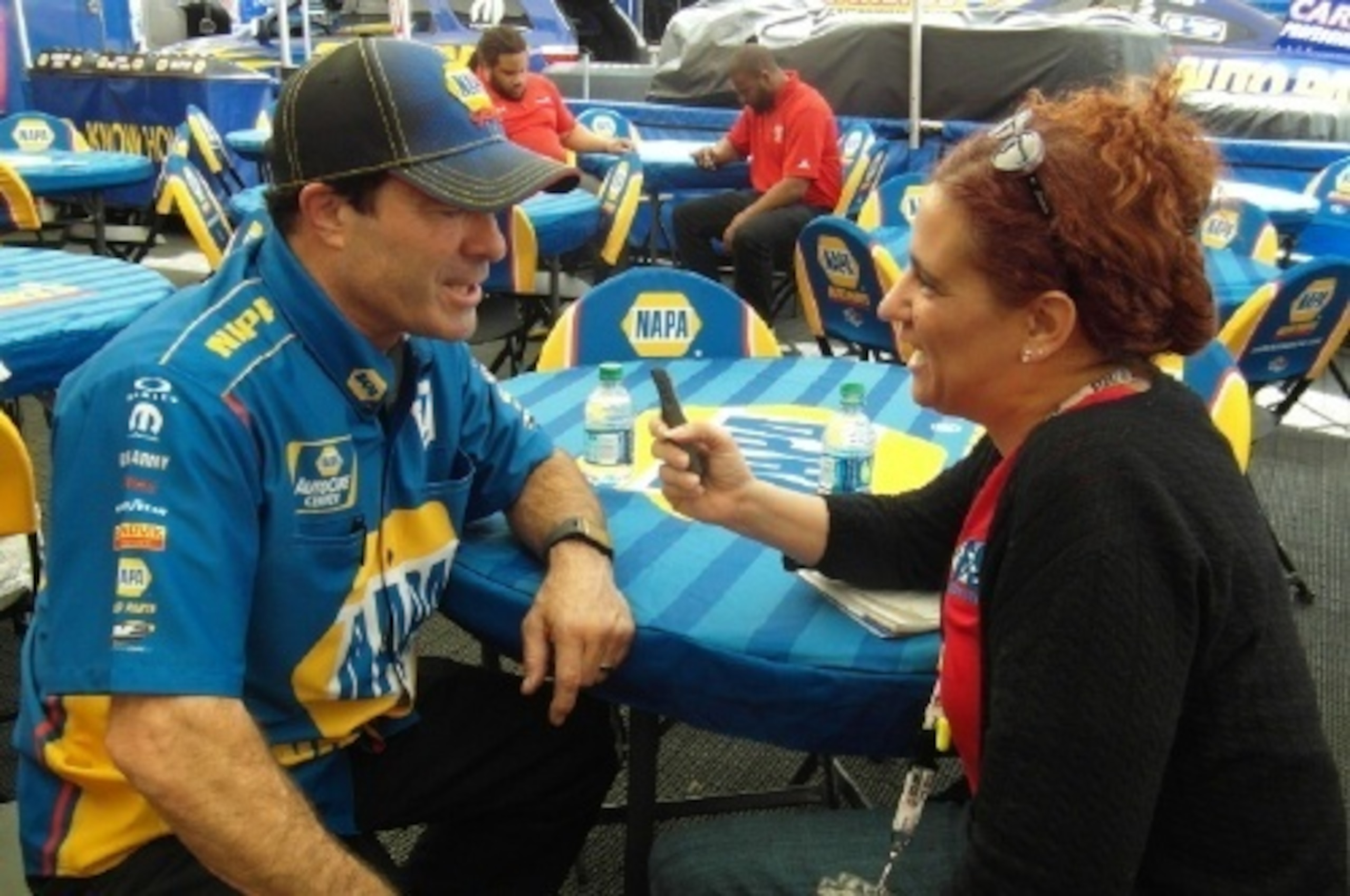 Ron Capps answers Toni Montgomery's questions in the Don Schumacher Racing hospitality area.