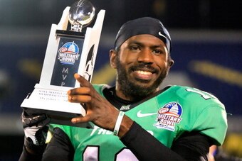 ANNAPOLIS, MD - DECEMBER 27: Quarterback Rakeem Cato #12 of the Marshall Thundering Herd holds up the MVP trophy after the Herd defeated the Maryland Terrapins 31-20 to win the 2013 Military Bowl at Navy Marine Corps Memorial Stadium on December 27, 2013 