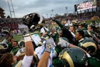 Dec 21, 2013; Albuquerque, NM, USA; Colorado State Rams celebrate on the field after defeating the Washington State Cougars during the Gildan New Mexico Bowl at University Stadium. The Rams defeated the Cougars 48-45. Mandatory Credit: Mark J. Rebilas-USA