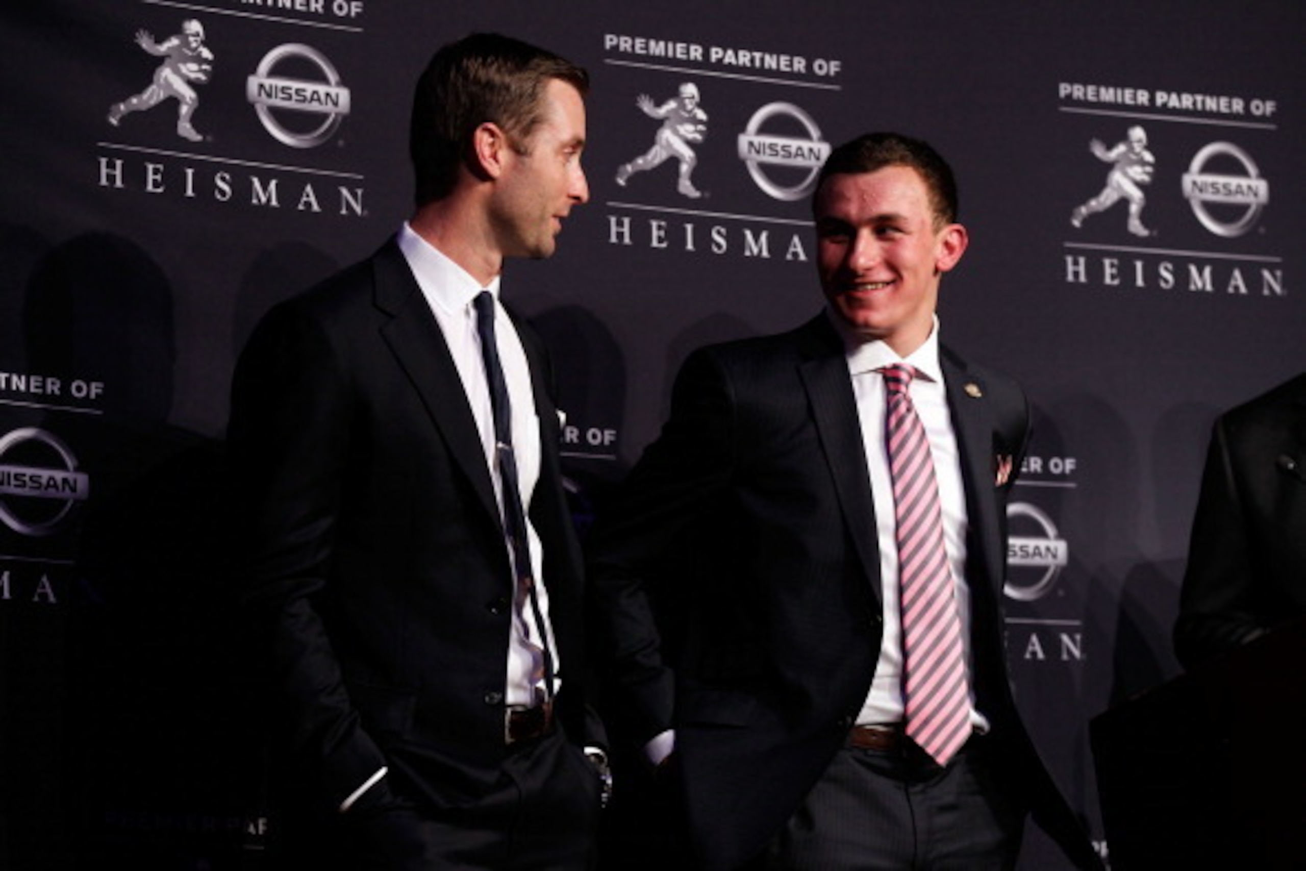 NEW YORK, NY - DECEMBER 08:  (L-R) Offensive Coordinator/Quarterbacks Kliff Kingsbury quarterback Johnny Manziel of the Texas A&M University Aggies pose after being named the 78th Heisman Memorial Trophy Award winner at a press conference at the Marriott 