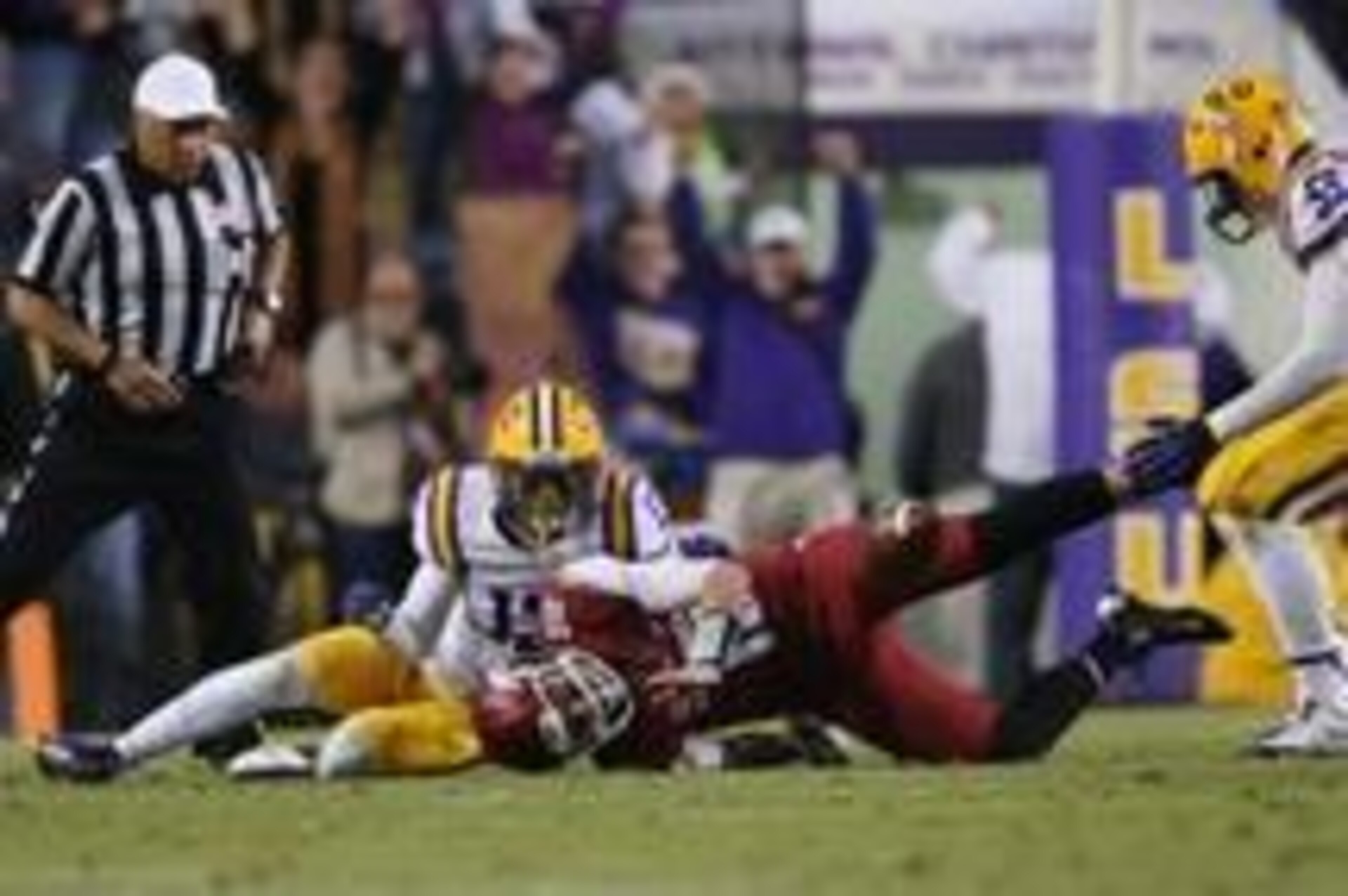 Nov 29, 2013; Baton Rouge, LA, USA; Arkansas Razorbacks quarterback Brandon Allen (10) fumbles the ball between LSU Tigers defensive end Jermauria Rasco (59) and cornerback Dwayne Thomas (13) in the fourth quarter at Tiger Stadium. LSU defeated Arkansas 3