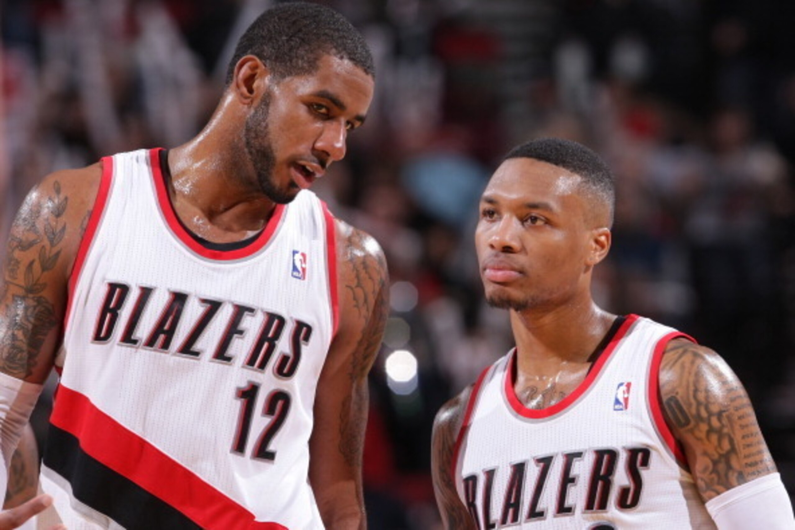 PORTLAND, OR - JANUARY 28:  LaMarcus Aldridge #12 and Damian Lillard #0 of the Portland Trail Blazers talk against the Memphis Grizzlies on January 28, 2014 at the Moda Center Arena in Portland, Oregon. NOTE TO USER: User expressly acknowledges and agrees