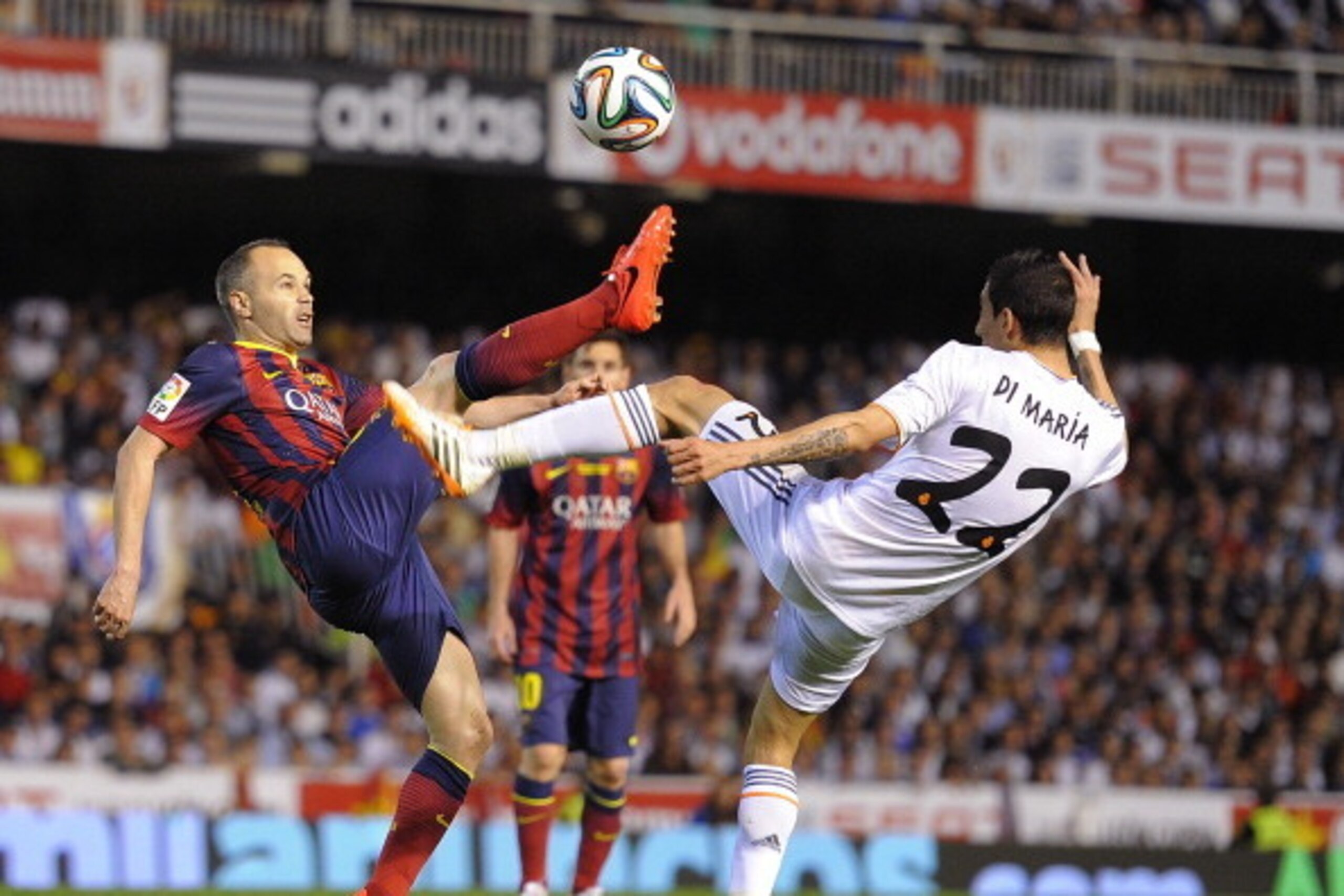 VALENCIA, SPAIN - APRIL 16:  Andres Iniesta (L) of FC Barcelona battles for the ball against Angel Di Maria of Real Madrid during the  Copa del Rey Final between Real Madrid and Barcelona at Estadio Mestalla on April 16, 2014 in Valencia, Spain.  (Photo b