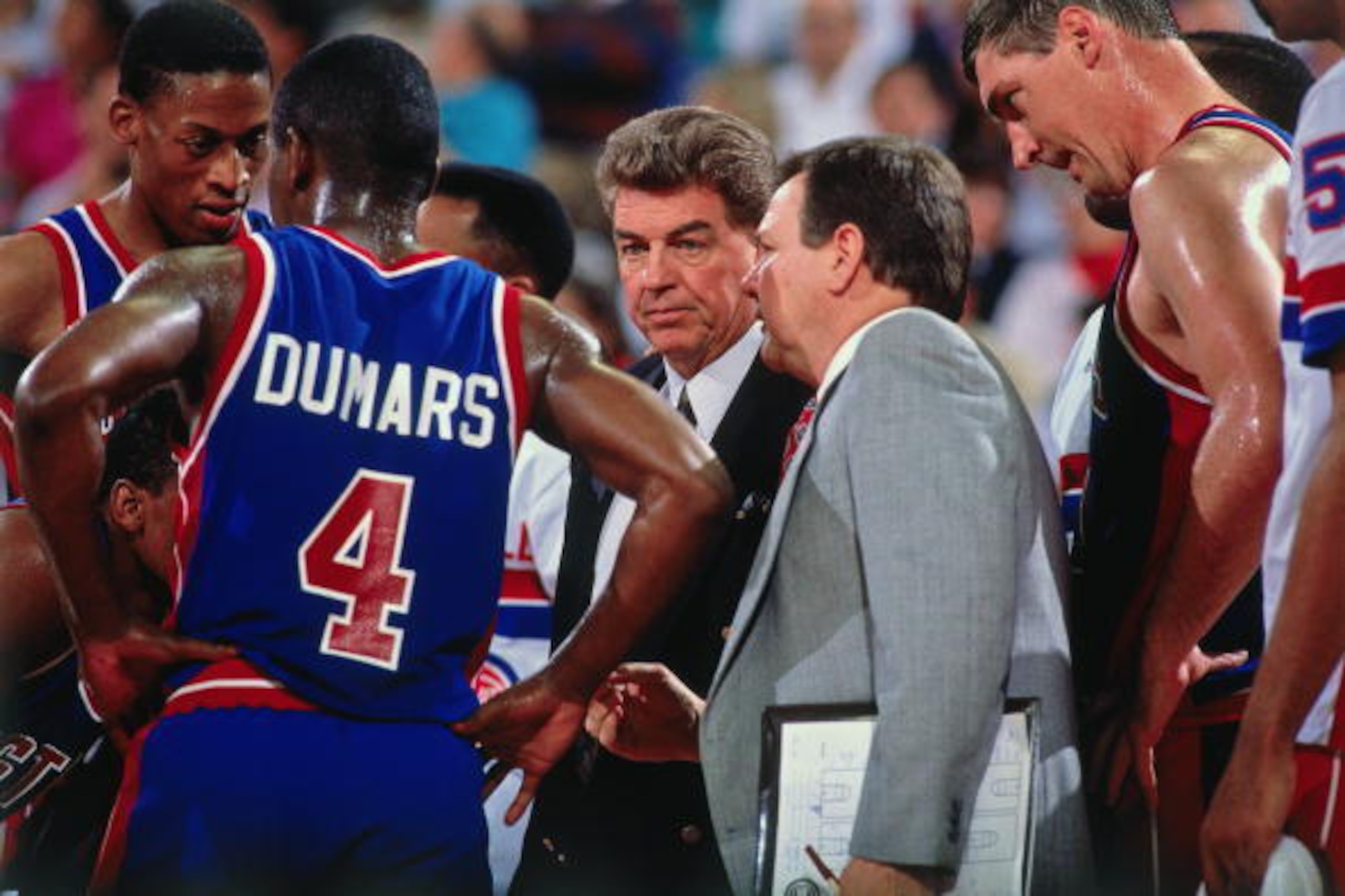 AUBURN HILLS, MI - 1990:  Head coach Chuck Daly of the Detroit Pistons talks with Joe Dumars during a game played in 1990 at the Palace of Auburn Hills in Auburn Hills, Michigan.  NOTE TO USER: User expressly acknowledges and agrees that, by downloading a