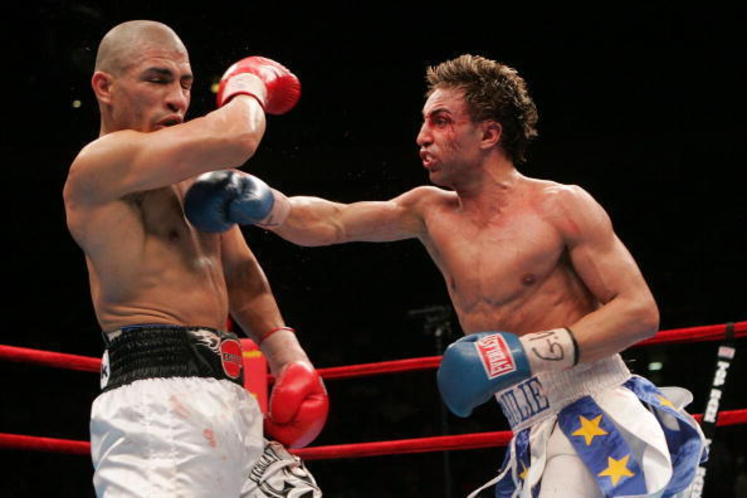 NEW YORK - JUNE 10:  (R-L) Paul Malignaggi makes contact with Miguel Cotto of Puerto Rico during their WBO Junior Welterweight Title on June 10, 2006 at Madison Square Garden in New York City.  (Photo by Nick Laham/Getty Images)