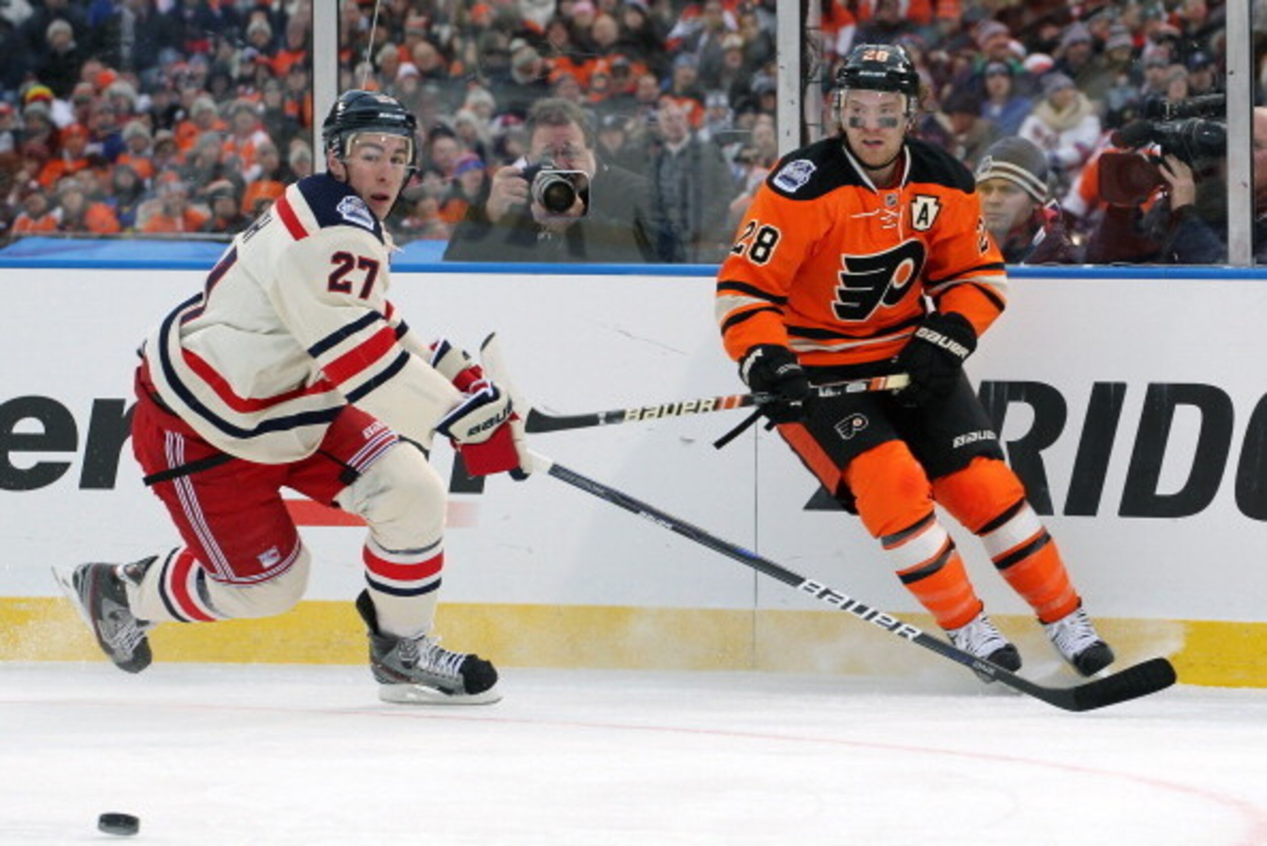 PHILADELPHIA, PA - JANUARY 02: Claude Giroux #28 of the Philadelphia Flyers skates after a loose puck against Ryan McDonagh #27 of the New York Rangers at the 2012 Bridgestone NHL Winter Classic on January 2, 2012 at Citizens Bank Park in Philadelphia, Pe