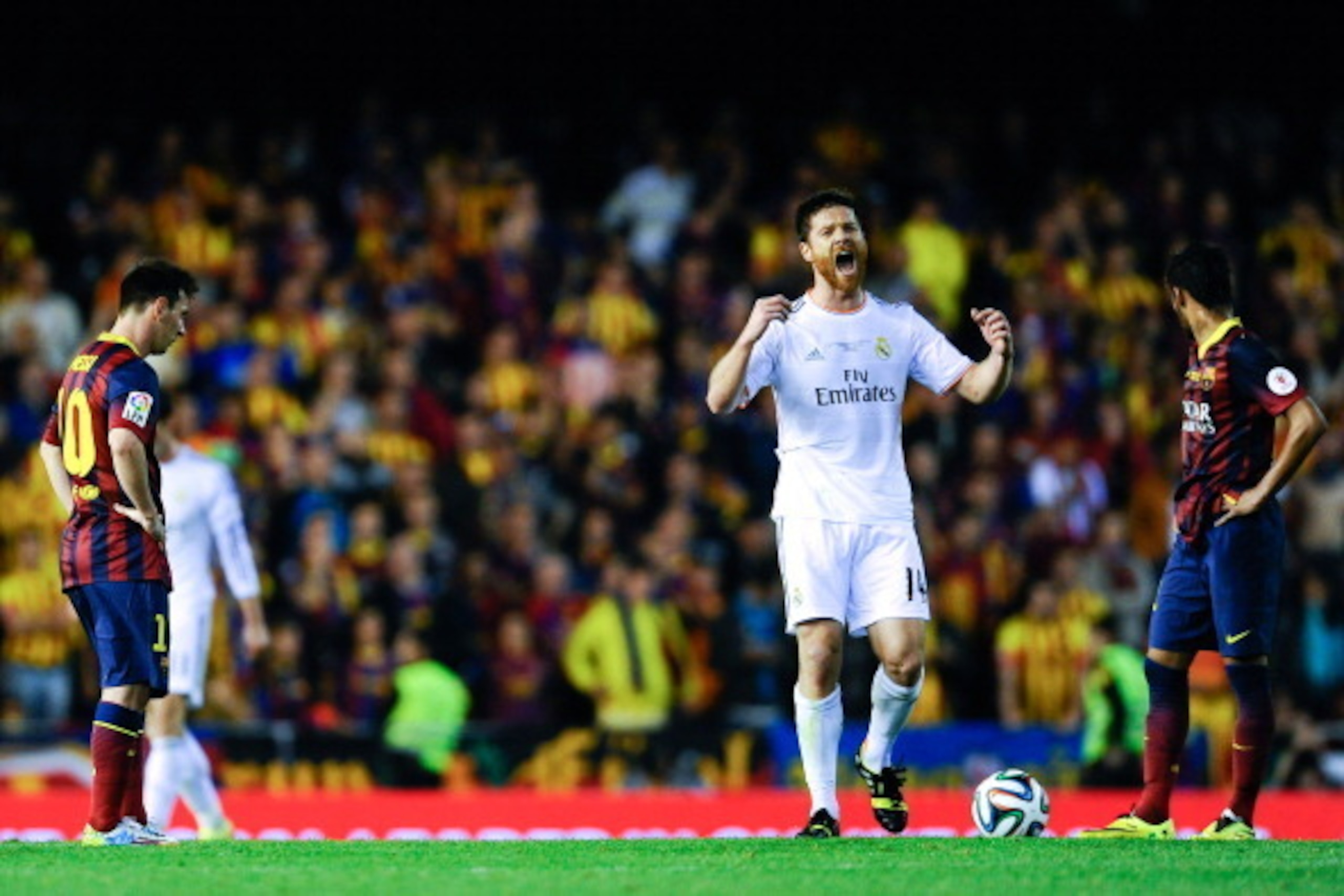 VALENCIA, SPAIN - APRIL 16:  Xabi Alonso of Real Madrid CF celebrates past Lionel Messi (L) and Neymar of FC Barcelona'aftyer his teammate Gareth Bale of Real Madrid CF scored the winning goal during the Copa del Rey Final between Real Madrid and FC Barce