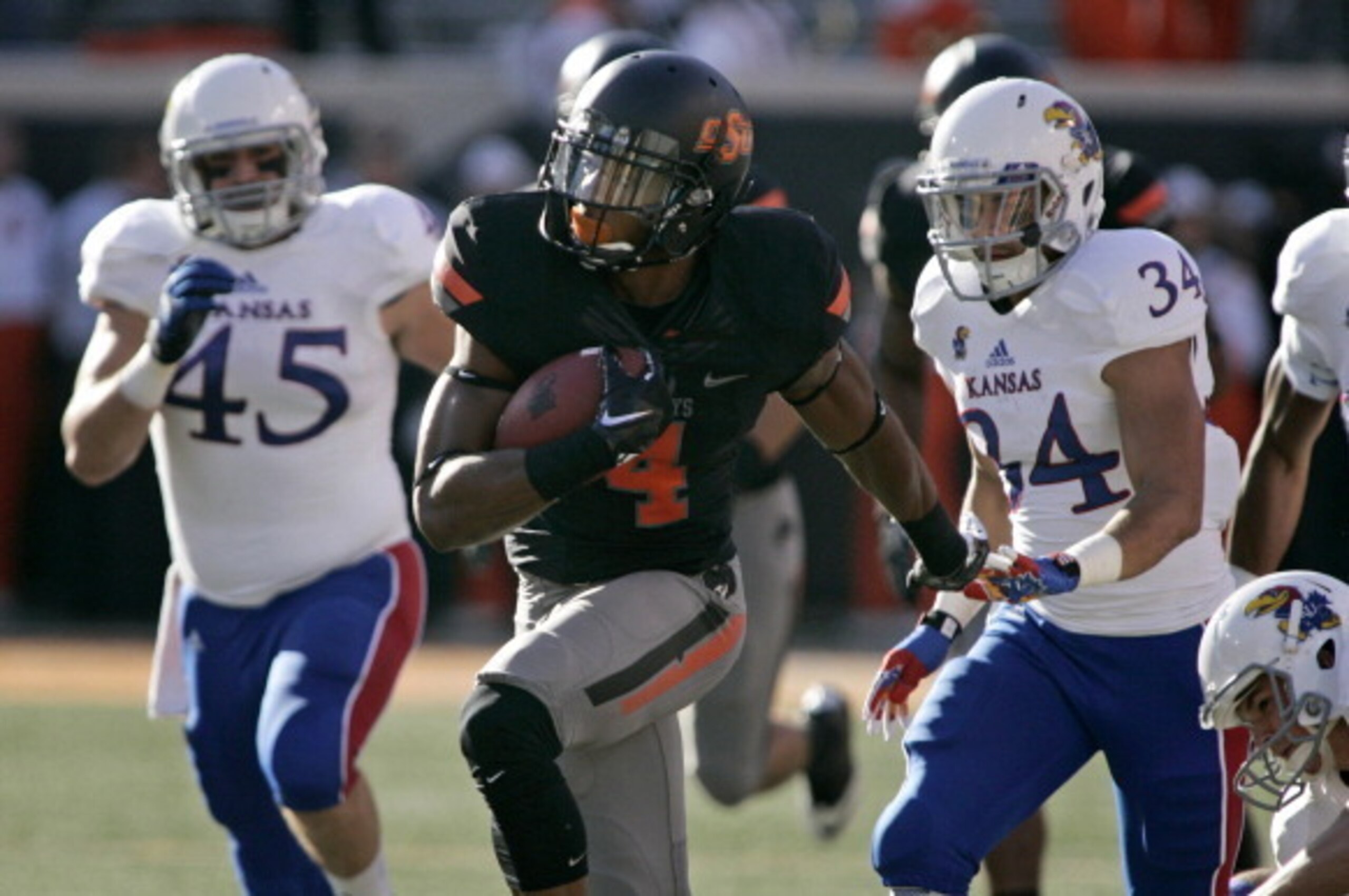 STILLWATER, OK - NOVEMBER 9:   Cornerback Justin Gilbert #4 of the Oklahoma State Cowboys runs downfield for a touchdown on the opening kickoff against the Kansas Jayhawks Novemeber 9, 2013 at Boone Pickens Stadium in Stillwater, Oklahoma.  (Photo by Bret
