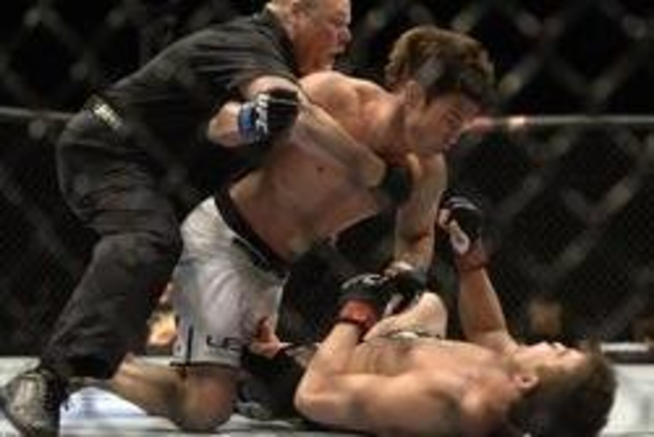 Apr 16, 2014; Quebec City, Quebec, Canada; Sam Stout ( red gloves), London, Ontario, Canada  was defeated by KO/TKO by  KJ Noons (blue gloves) , Kona, HI, USA during their light welterweight bout at Colisee Pepsi. Referee Philippe Chartier stopped the fig