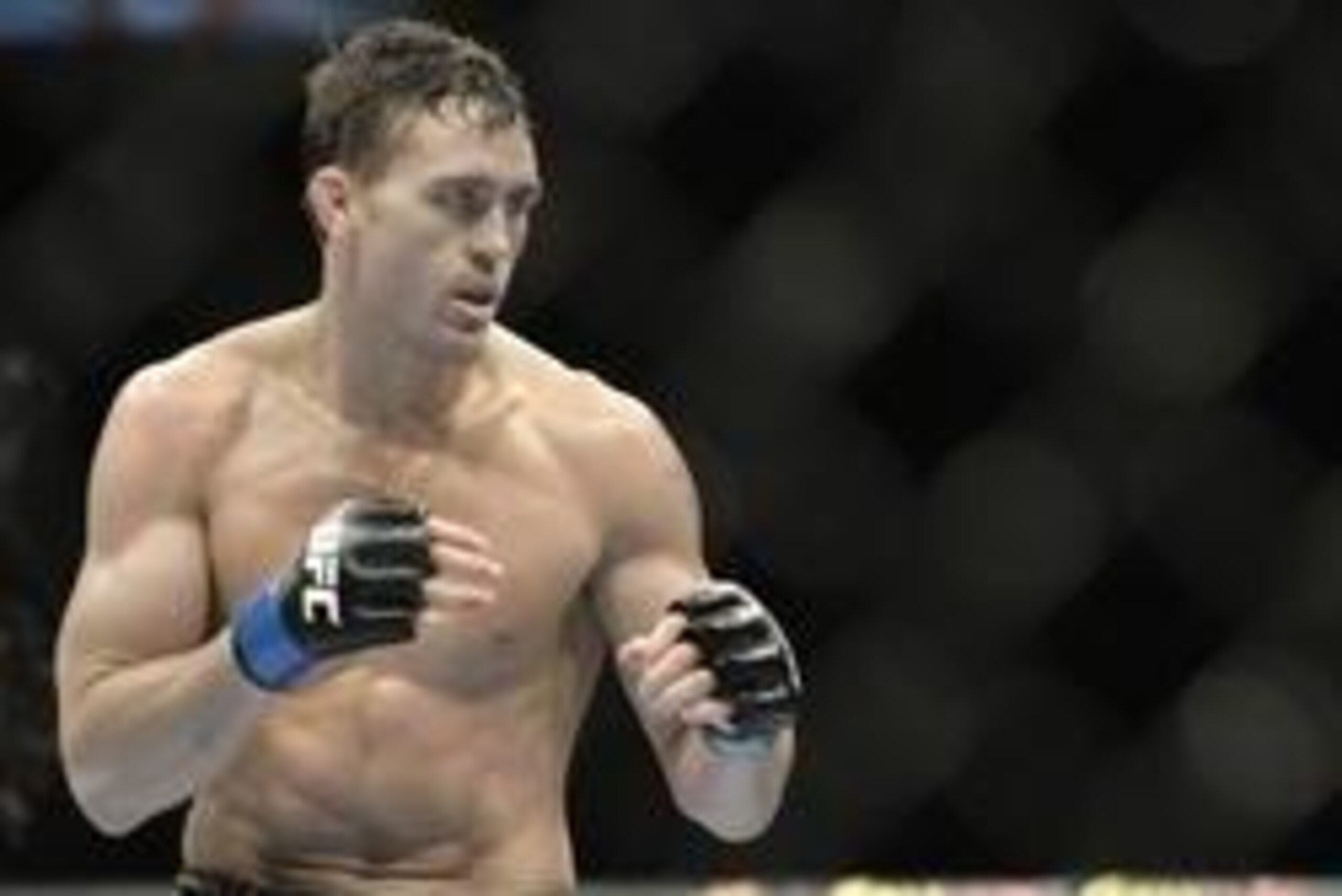 Apr 16, 2014; Quebec City, Quebec, Canada; Kyle Noke (blue gloves) fights against Patrick Cote (not pictured) during their welterweight bout at Colisee Pepsi. Mandatory Credit: Eric Bolte-USA TODAY Sports