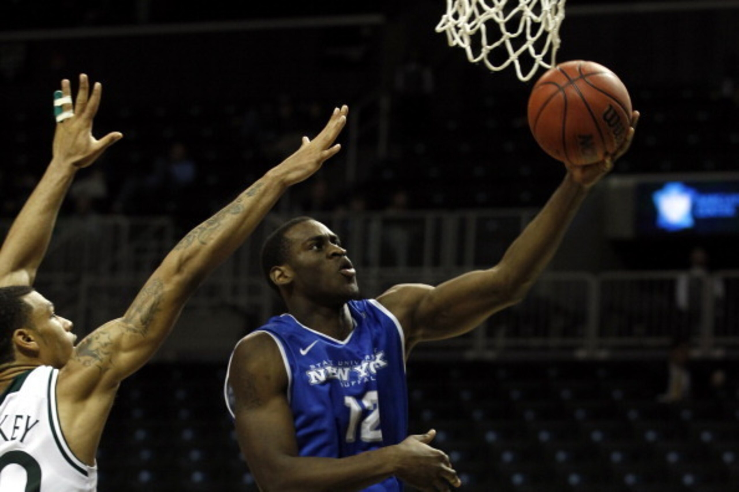 NEW YORK, NY - DECEMBER 21:  Javon McCrea #12 of the Buffalo Bulls drives to the basket past Ashton Pankey #30 of the Manhattan Jaspers during the Brooklyn Hoops Holiday Invitational at Barclays Center on December 21, 2013 in the Brooklyn borough of New Y