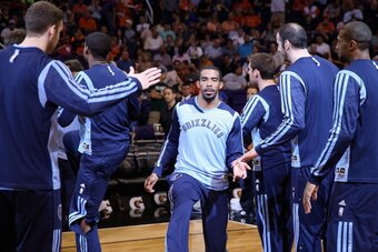 PHOENIX, AZ - APRIL 14:  Mike Conley #11 of the Memphis Grizzlies high fives teammates as he is introduced to the NBA game against the Phoenix Suns at US Airways Center on April 14, 2014 in Phoenix, Arizona.  NOTE TO USER: User expressly acknowledges and 
