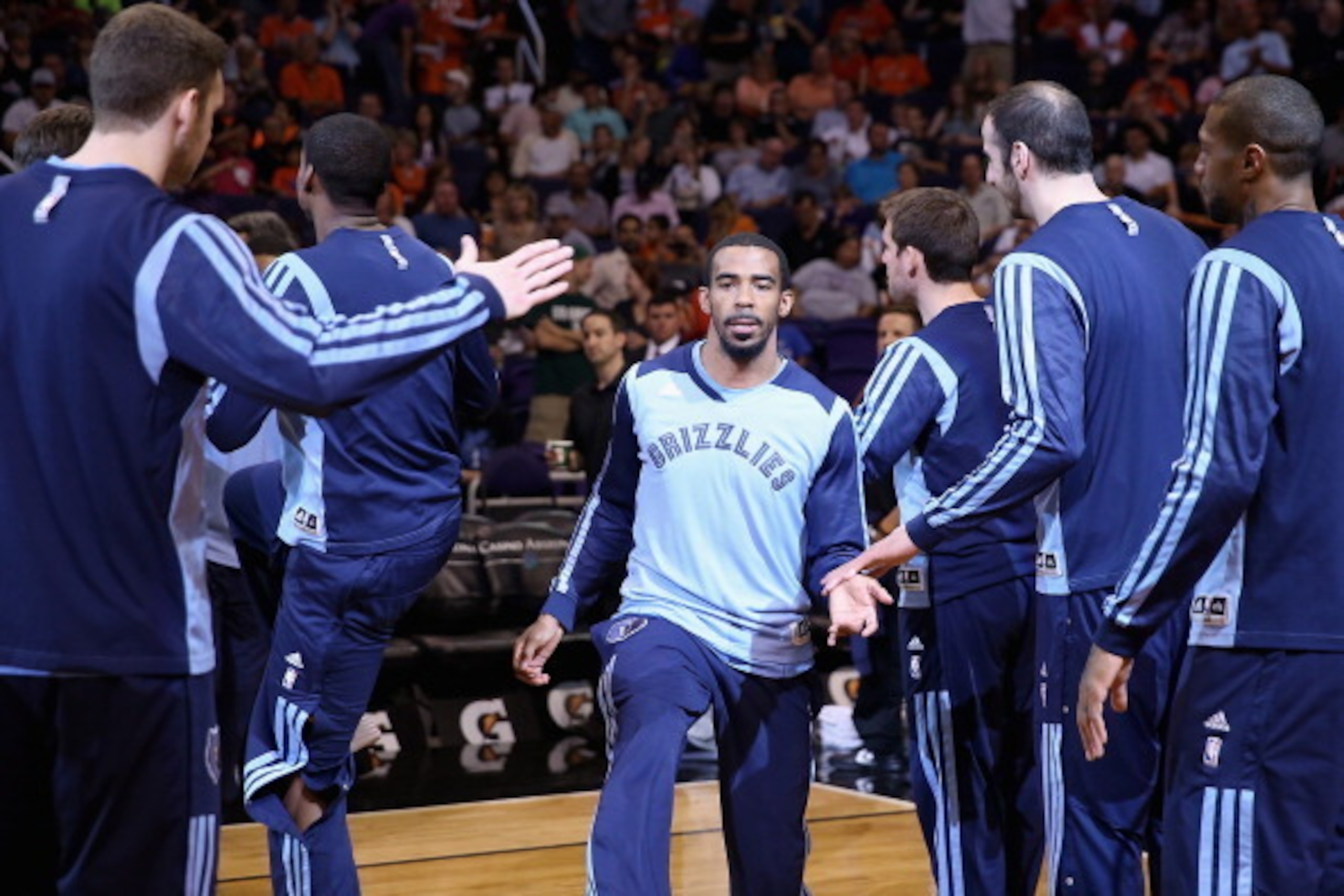 PHOENIX, AZ - APRIL 14: Mike Conley #11 of the Memphis Grizzlies high fives teammates as he is introduced to the NBA game against the Phoenix Suns at US Airways Center on April 14, 2014 in Phoenix, Arizona. NOTE TO USER: User expressly acknowledges and PHOENIX, AZ - APRIL 14: Mike Conley #11 of the Memphis Grizzlies high fives teammates as he is introduced to the NBA game against the Phoenix Suns at US Airways Center on April 14, 2014 in Phoenix, Arizona. NOTE TO USER: User expressly acknowledges and
