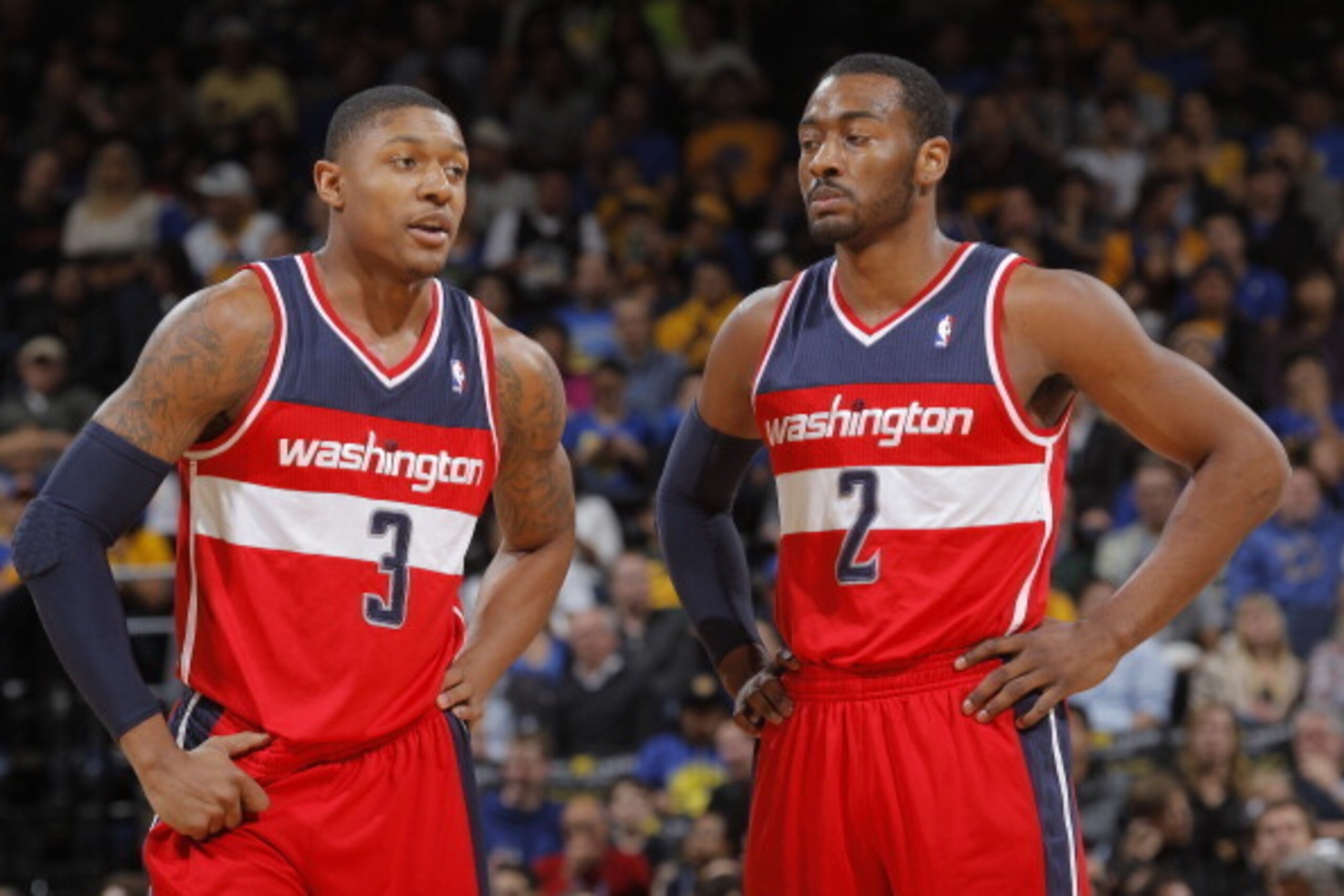 OAKLAND, CA - JANUARY 28: Bradley Beal #3 chats with teammate John Wall #2 of the Washington Wizards while facing the Golden State Warriors on January 28, 2014 at Oracle Arena in Oakland, California. NOTE TO USER: User expressly acknowledges and agrees th