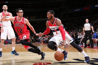 WASHINGTON, DC - APRIL 5: John Wall #2 of the Washington Wizards drives against Kirk Hinrich #12 of the Chicago Bulls during the game at the Verizon Center on April 5, 2014 in Washington, DC. NOTE TO USER: User expressly acknowledges and agrees that, by d