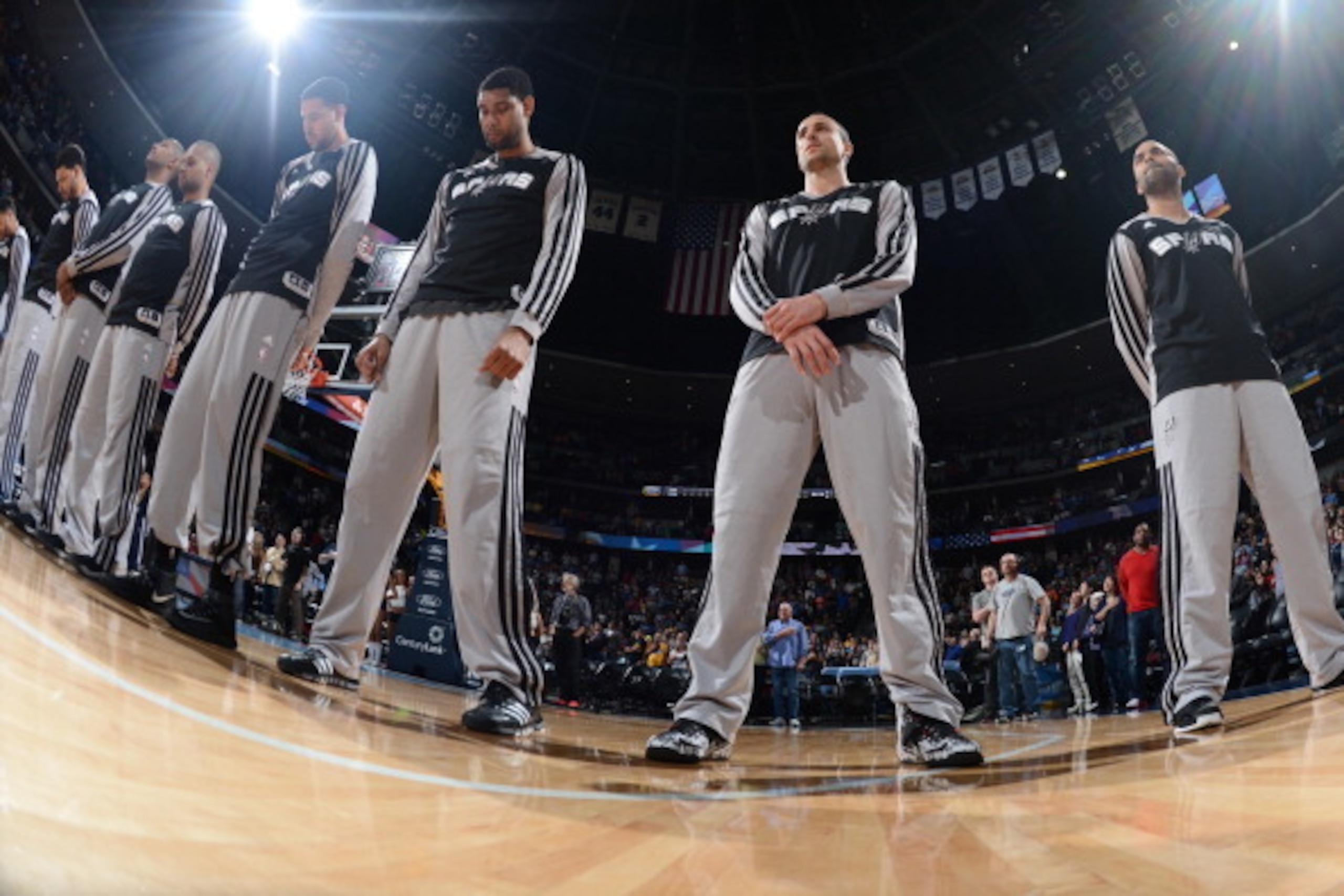 DENVER, CO - MARCH 28:  Tim Duncan #21, Manu Ginobili #20 and Tony Parker #9 of the San Antonio Spurs stand on the court before the game against the Denver Nuggets on March 28, 2014 at the Pepsi Center in Denver, Colorado. NOTE TO USER: User expressly ack