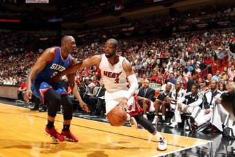 MIAMI, FL - April 16: Dwyane Wade #3 of the Miami Heat drives against James Anderson #9 of the Philadelphia 76ers at the American Airlines Arena in Miami, Florida on April 16, 2014. NOTE TO USER: User expressly acknowledges and agrees that, by downloading