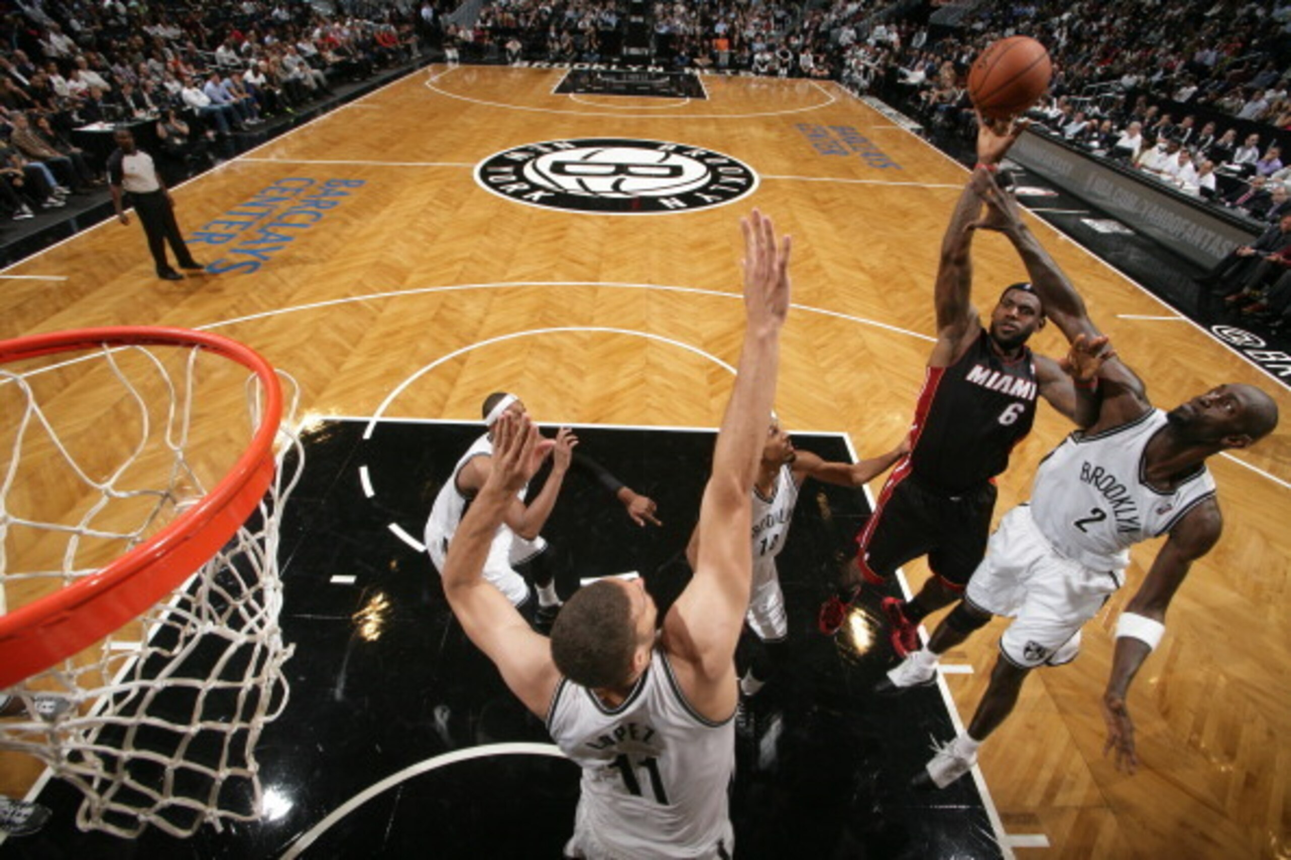 NEW YORK, NY - OCTOBER 17: LeBron James #6 of the Miami Heat shoots against Brook Lopez #11 and Kevin Garnett #2 of the Brooklyn Nets during a preseason game at the Barclays Center on October 17, 2013 in the Brooklyn borough of New York City.  NOTE TO USE