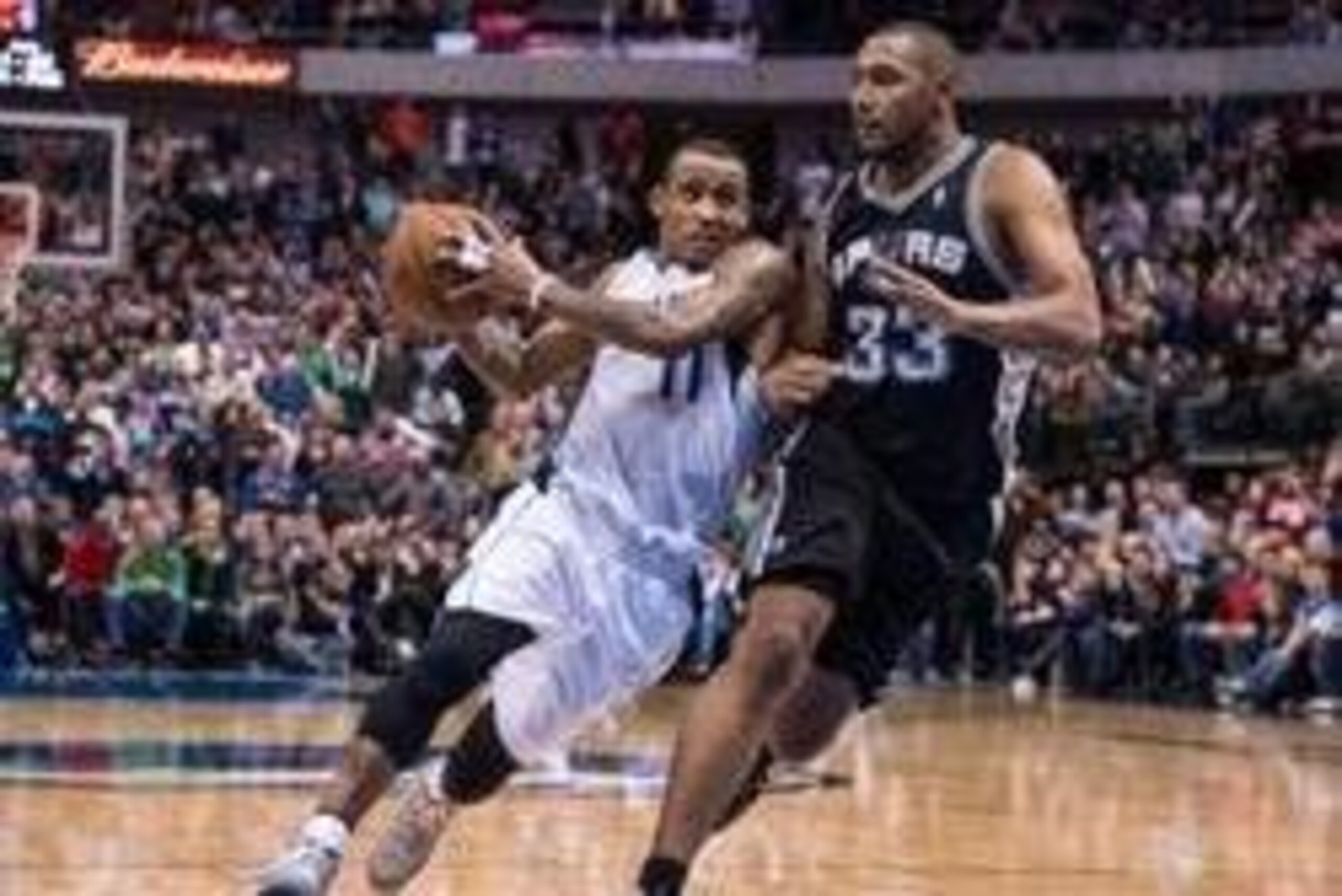 Dec 26, 2013; Dallas, TX, USA; Dallas Mavericks shooting guard Monta Ellis (11) drives to the basket past San Antonio Spurs power forward Boris Diaw (33) during the game at the American Airlines Center. The Spurs defeated the Mavericks 116-107. Mandatory 